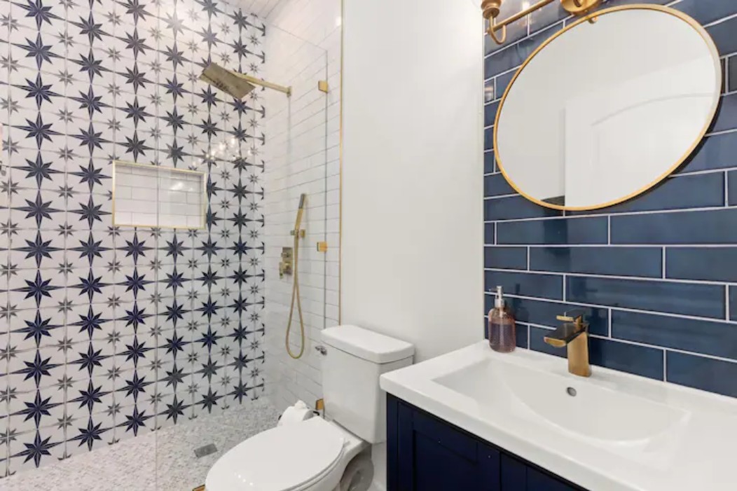 2319 Santa Rita Street Austin, TX 78702 - Photo 16 of 26 Full bathroom with vanity, a tile shower, and decorative backsplash