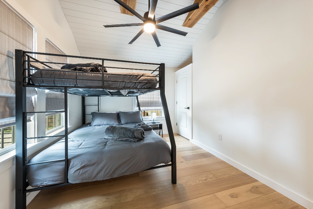 2319 Santa Rita Street Austin, TX 78702 - Photo 19 of 26 Bedroom with light wood-style floors, vaulted ceiling, and a ceiling fan