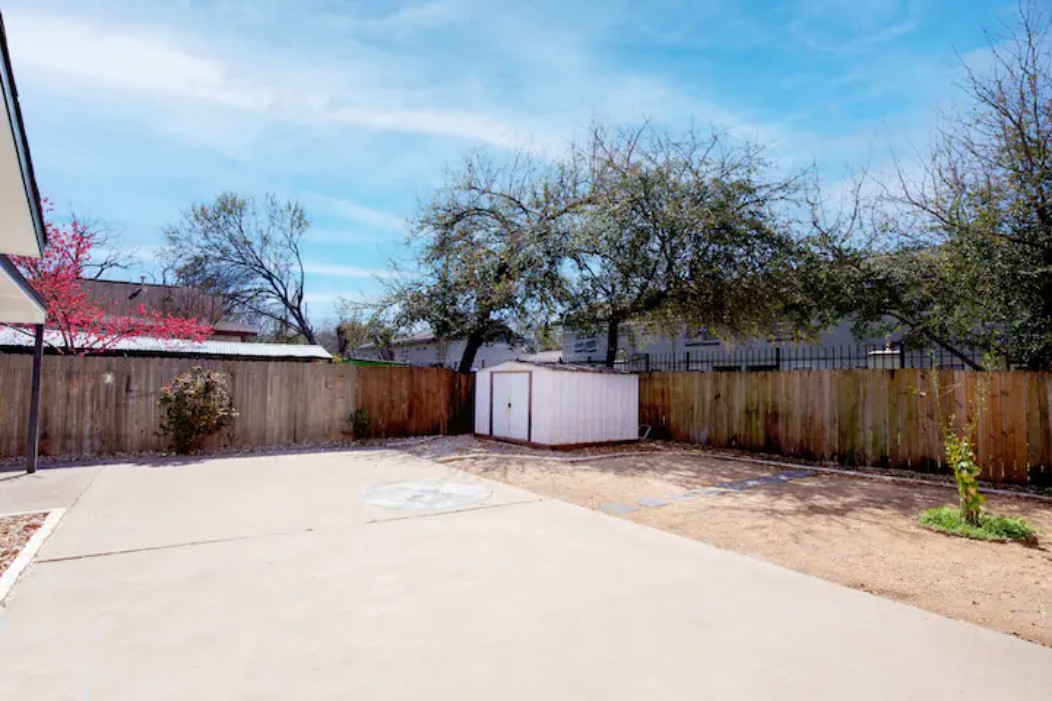 2319 Santa Rita Street Austin, TX 78702 - Photo 23 of 26 Fenced backyard featuring a shed and a patio area