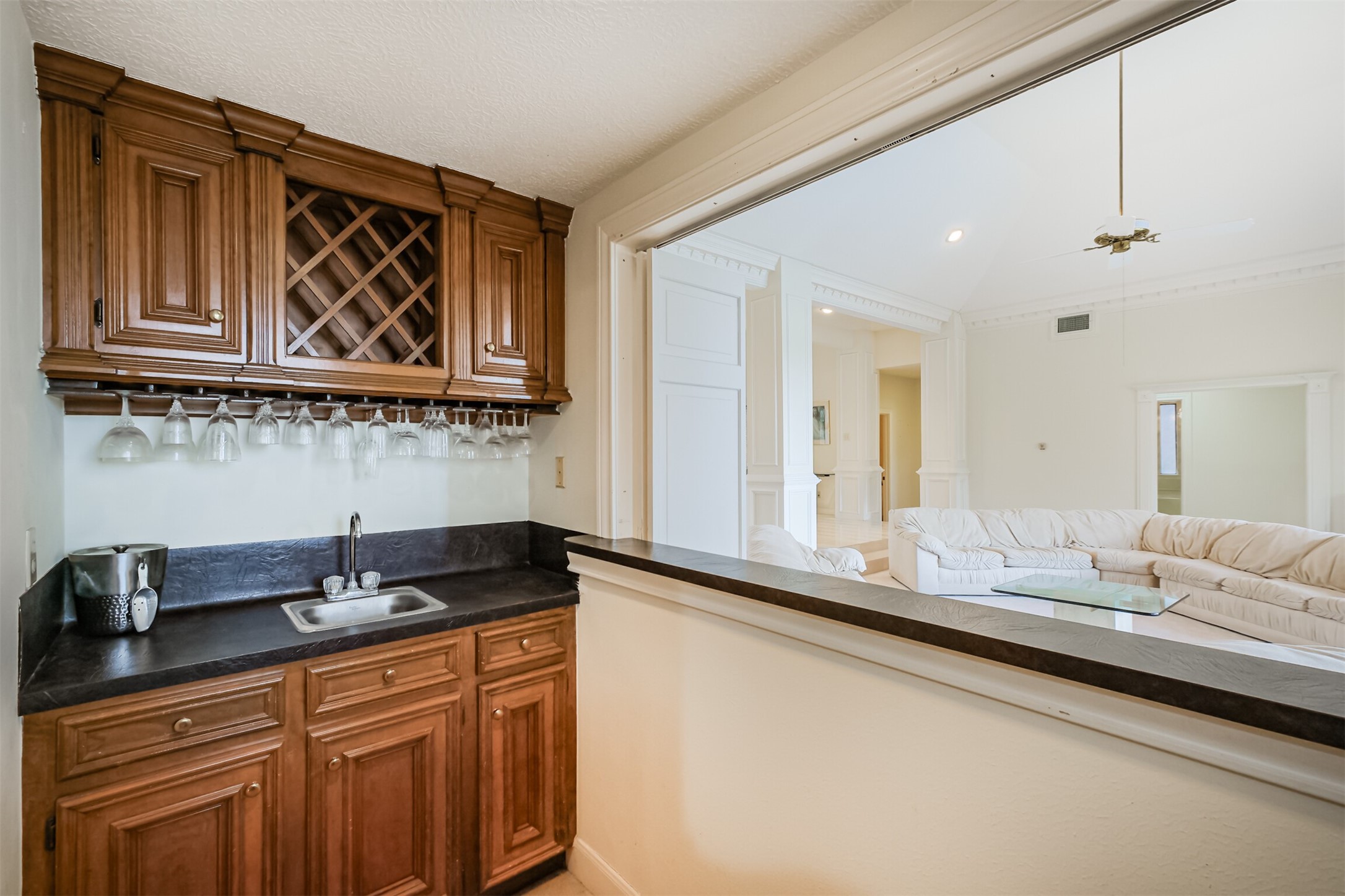 32726 Weybridge Street Fulshear, TX 77441 - Photo 17 of 50 a kitchen with granite countertop a sink and cabinets
