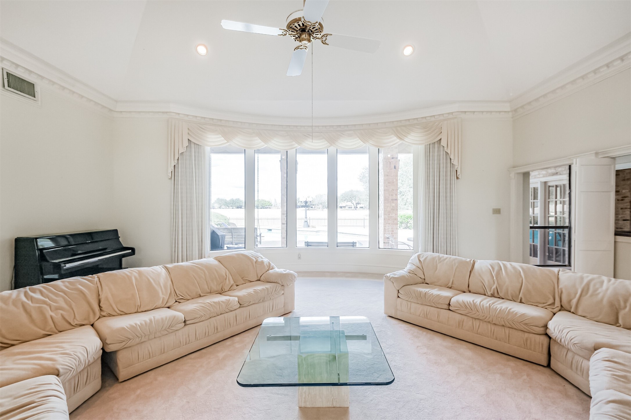 32726 Weybridge Street Fulshear, TX 77441 - Photo 7 of 50 a living room with furniture a chandelier and a window