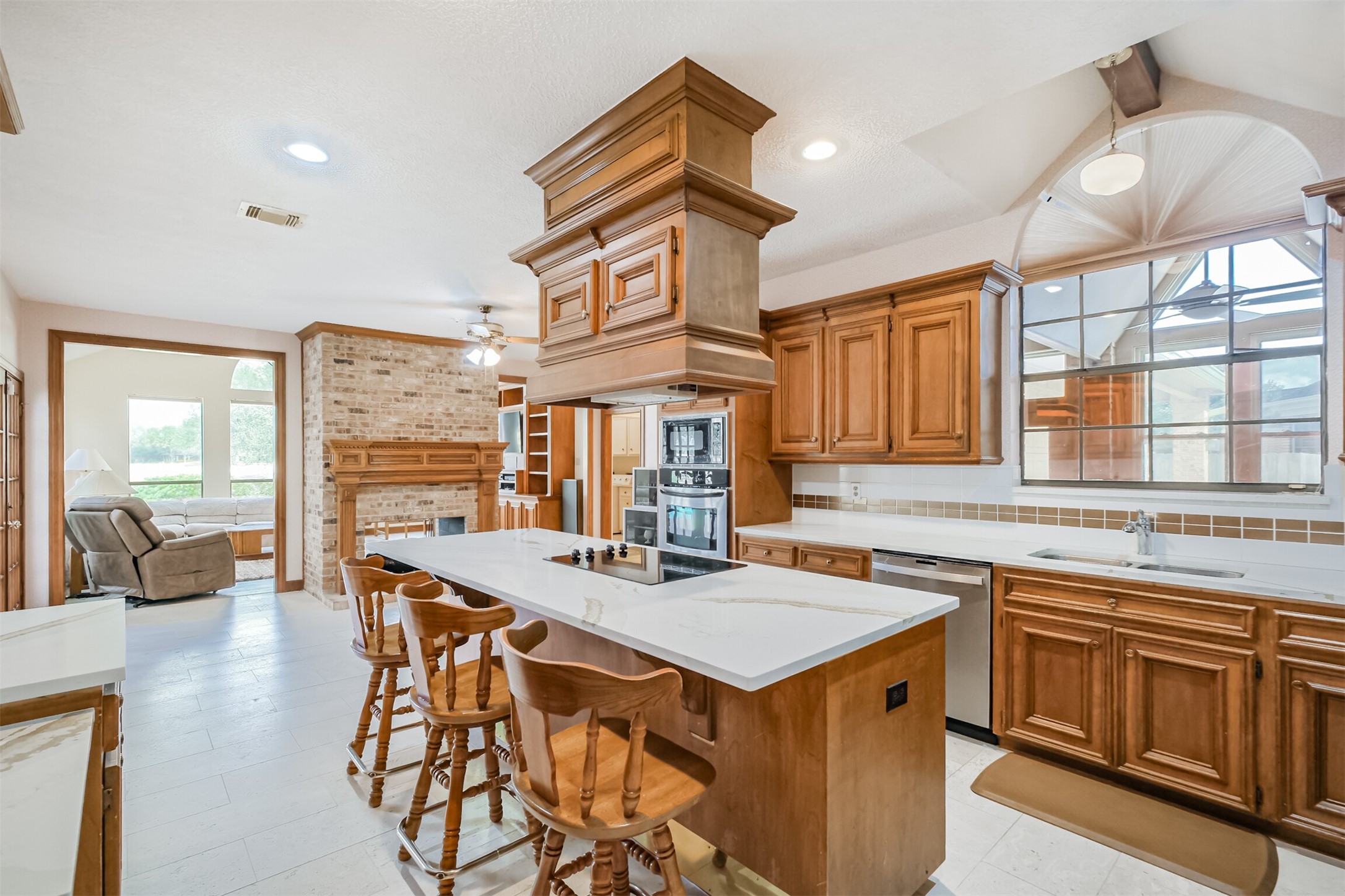 32726 Weybridge Street Fulshear, TX 77441 - Photo 10 of 50 a kitchen that has a lot of cabinets in it and wooden floors