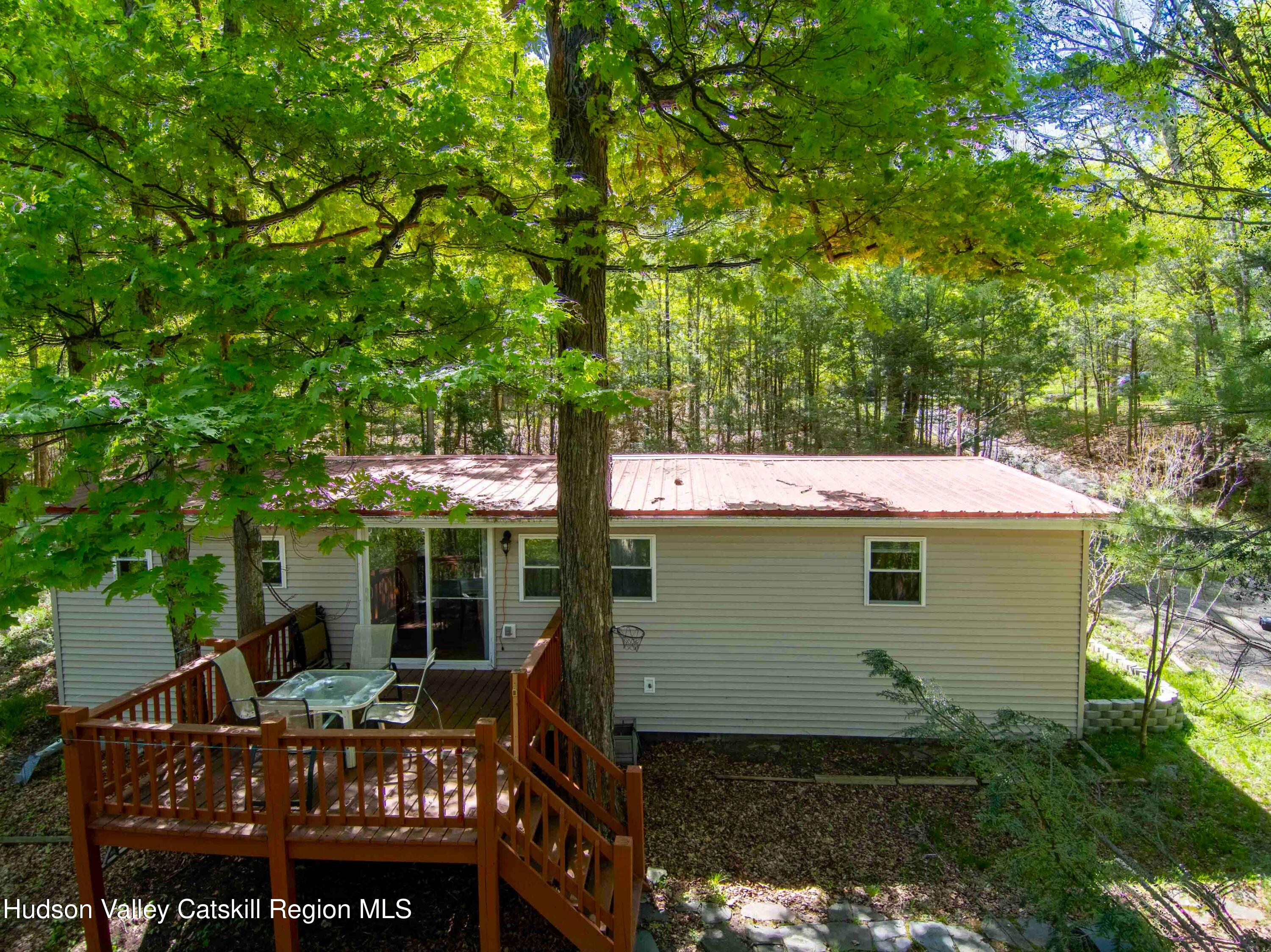 a view of a house with backyard porch and sitting area