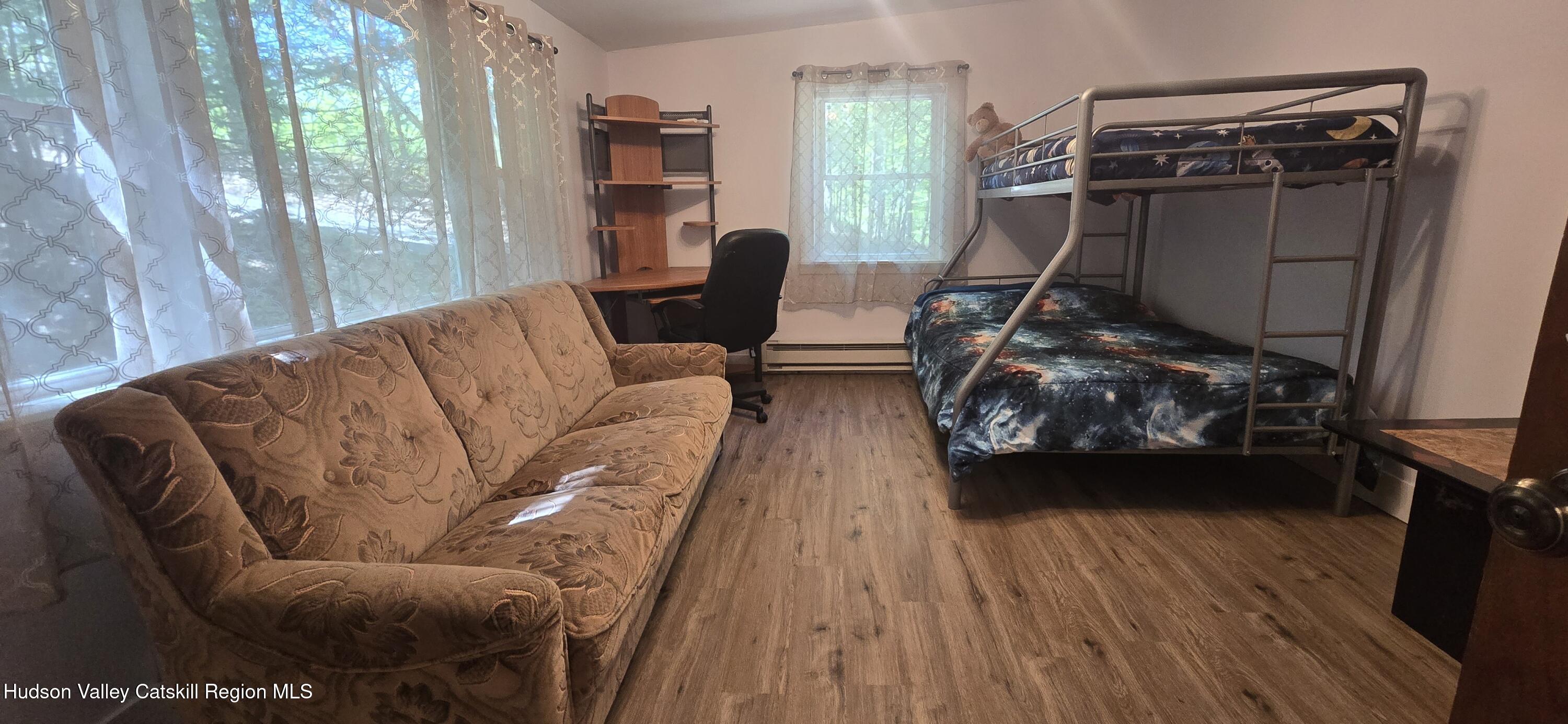 51 Enchanted Valley Road Cornwallville, NY 12418 - Photo 11 of 21 a living room with furniture and a wooden floor