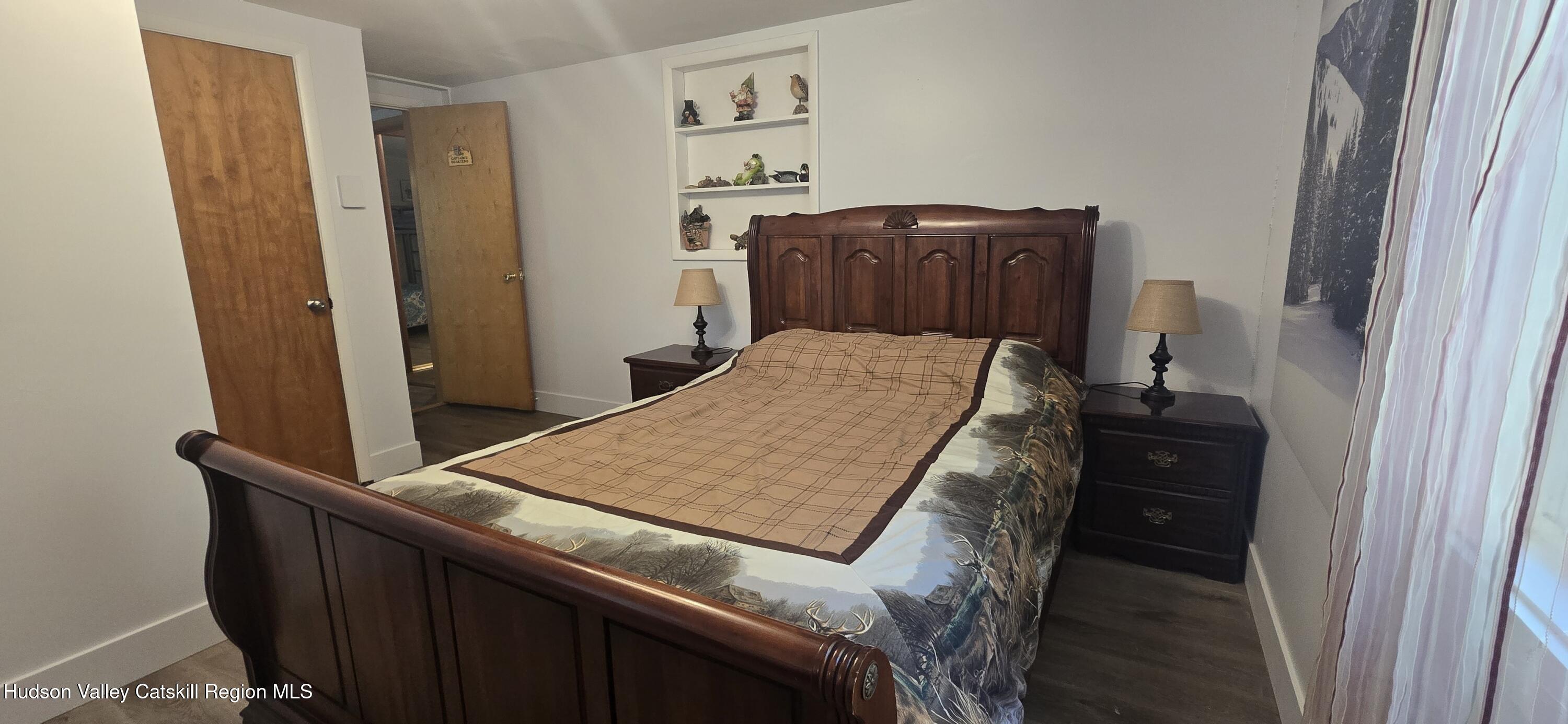 51 Enchanted Valley Road Cornwallville, NY 12418 - Photo 14 of 21 a bed sitting in a bedroom next to a window