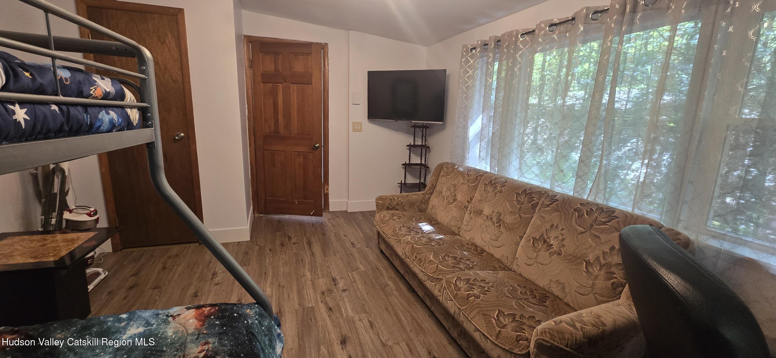 51 Enchanted Valley Road Cornwallville, NY 12418 - Photo 10 of 21 a living room with furniture and a flat screen tv