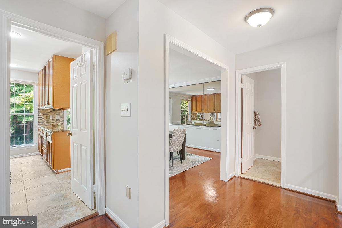 2757 Unicorn Lane Northwest Washington, DC 20015 - Photo 15 of 43 a view of a hallway with wooden floor and a bathroom