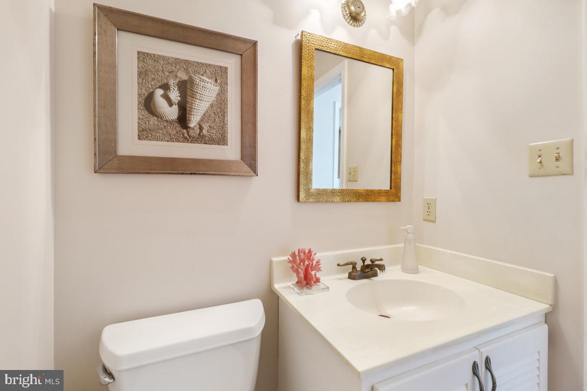 2757 Unicorn Lane Northwest Washington, DC 20015 - Photo 16 of 43 a bathroom with a toilet a sink and a mirror