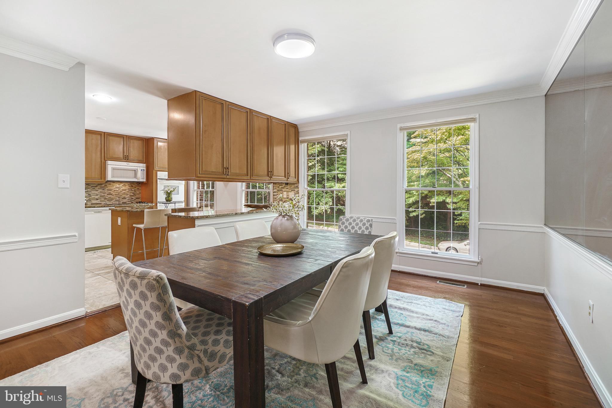 2757 Unicorn Lane Northwest Washington, DC 20015 - Photo 18 of 43 a kitchen with a table chairs and a refrigerator