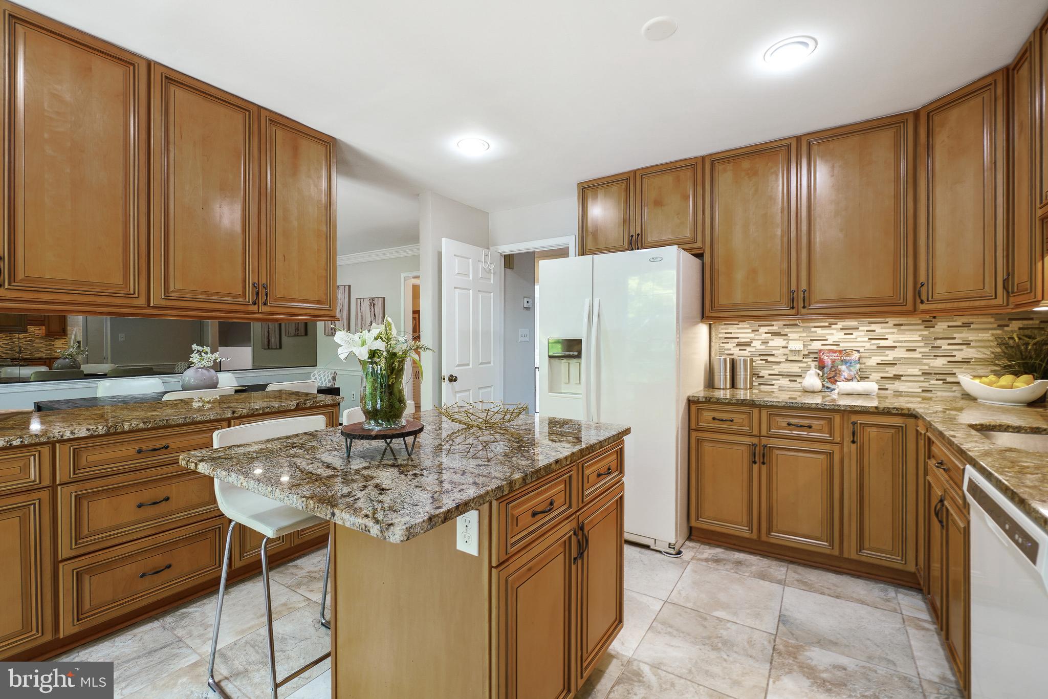 2757 Unicorn Lane Northwest Washington, DC 20015 - Photo 23 of 43 a kitchen with stainless steel appliances granite countertop wooden cabinets a refrigerator a stove a sink and dishwasher