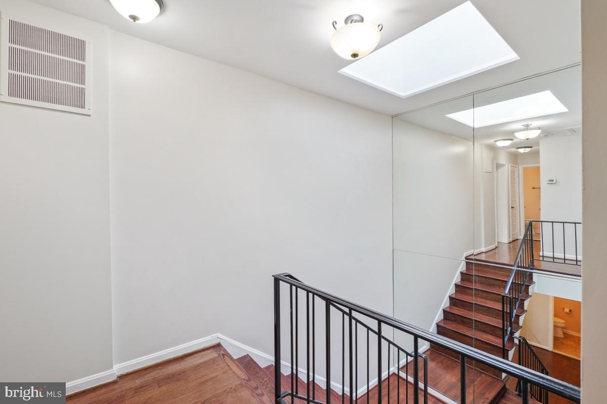 2757 Unicorn Lane Northwest Washington, DC 20015 - Photo 26 of 43 a view of a hallway with wooden floor and stairs