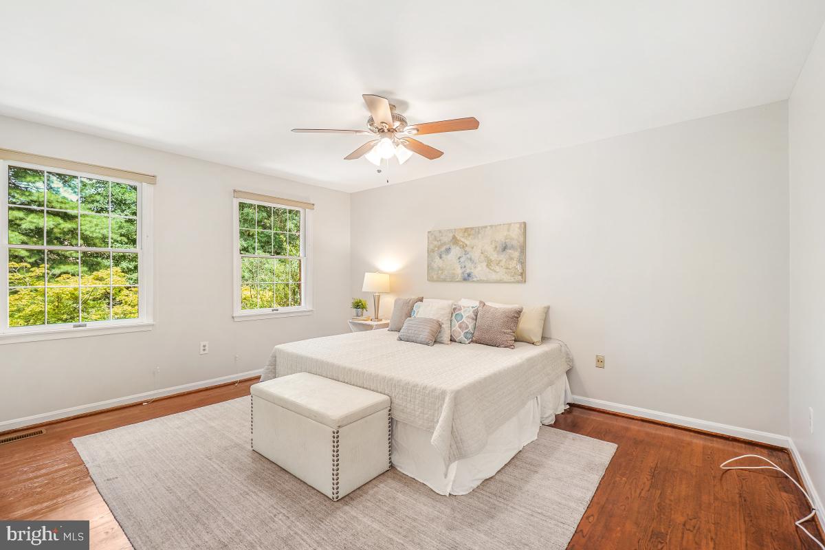 2757 Unicorn Lane Northwest Washington, DC 20015 - Photo 28 of 43 a bedroom with a bed and a chandelier