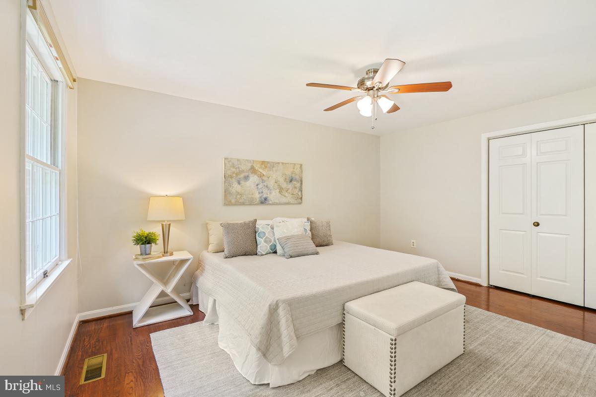 2757 Unicorn Lane Northwest Washington, DC 20015 - Photo 29 of 43 a bedroom with a bed and a chandelier
