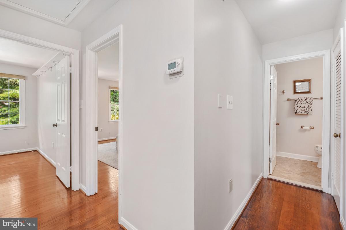 2757 Unicorn Lane Northwest Washington, DC 20015 - Photo 30 of 43 a view of a hallway with wooden floor and closet area