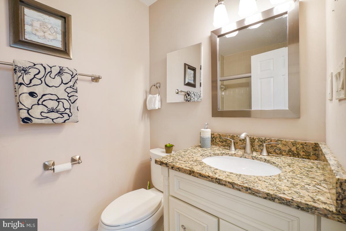 2757 Unicorn Lane Northwest Washington, DC 20015 - Photo 31 of 43 a bathroom with a granite countertop sink and a mirror