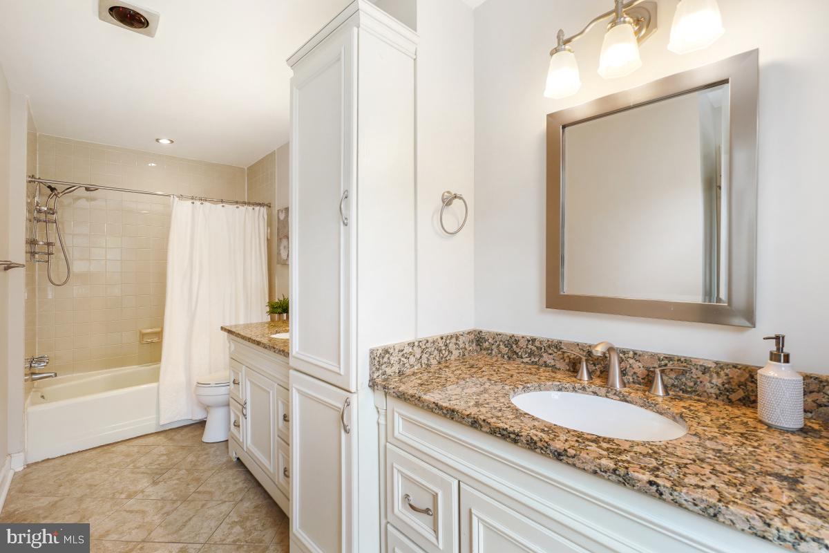2757 Unicorn Lane Northwest Washington, DC 20015 - Photo 35 of 43 a bathroom with a granite countertop sink and a mirror