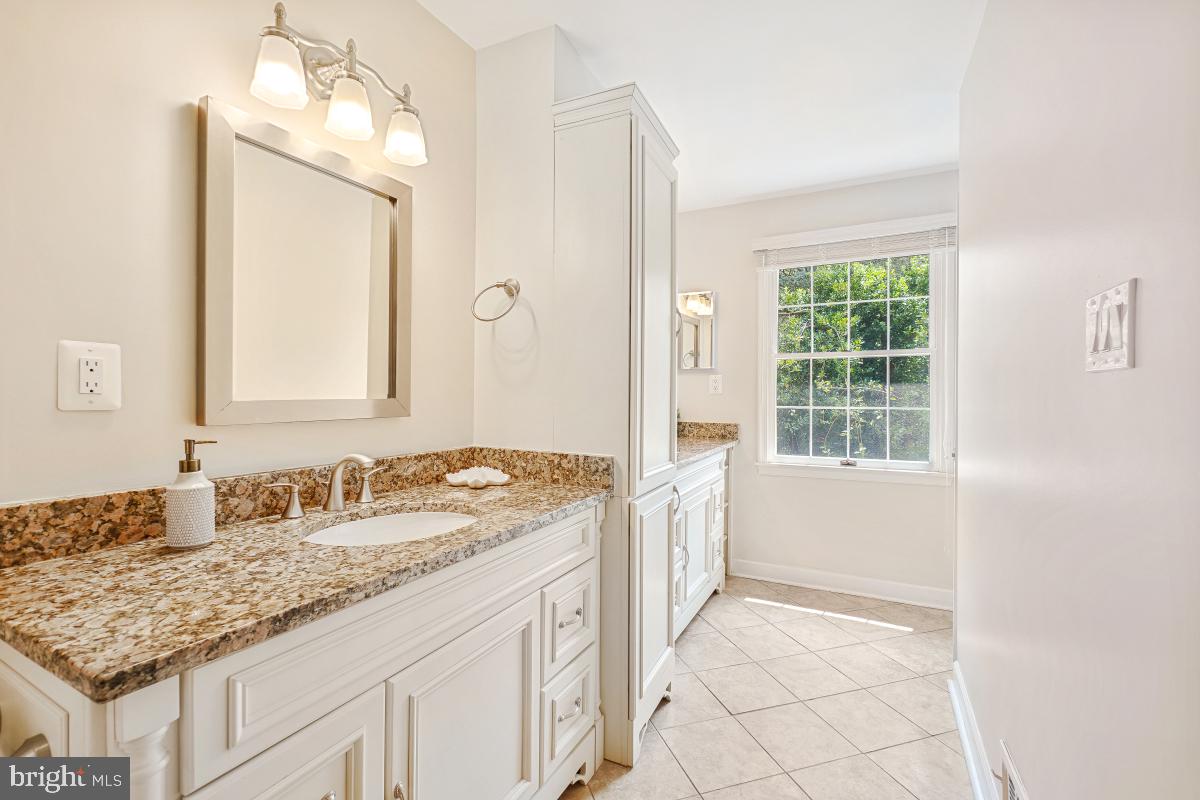 2757 Unicorn Lane Northwest Washington, DC 20015 - Photo 36 of 43 a bathroom with a granite countertop sink and a mirror
