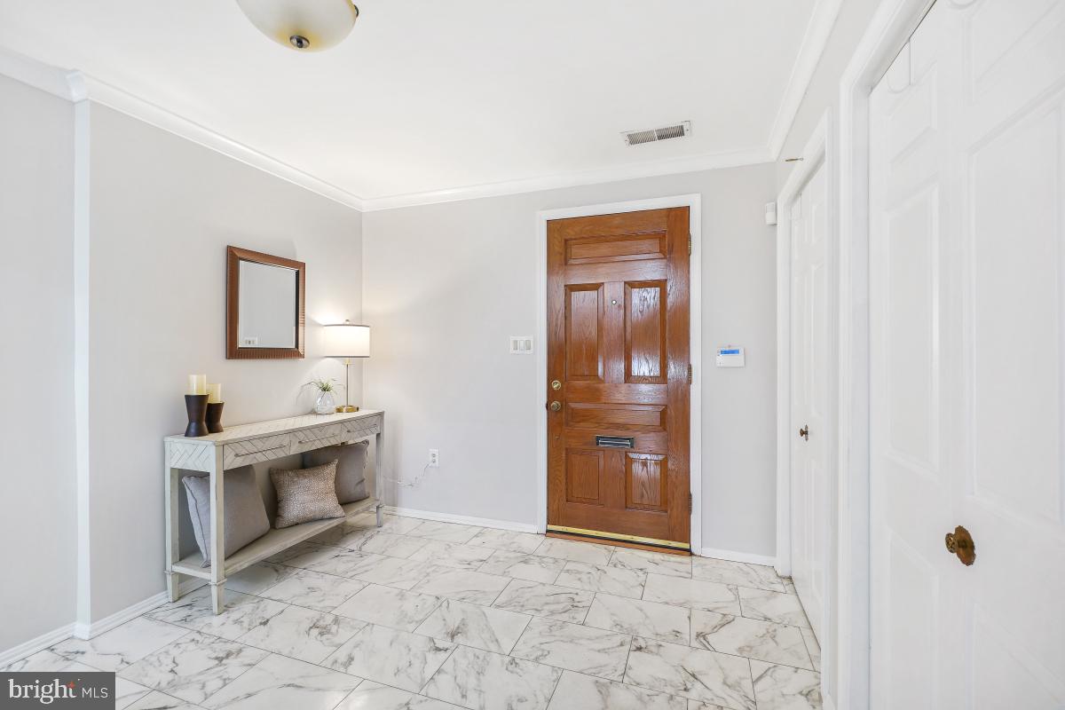 2757 Unicorn Lane Northwest Washington, DC 20015 - Photo 5 of 43 a view of a hallway with a sink and a fireplace