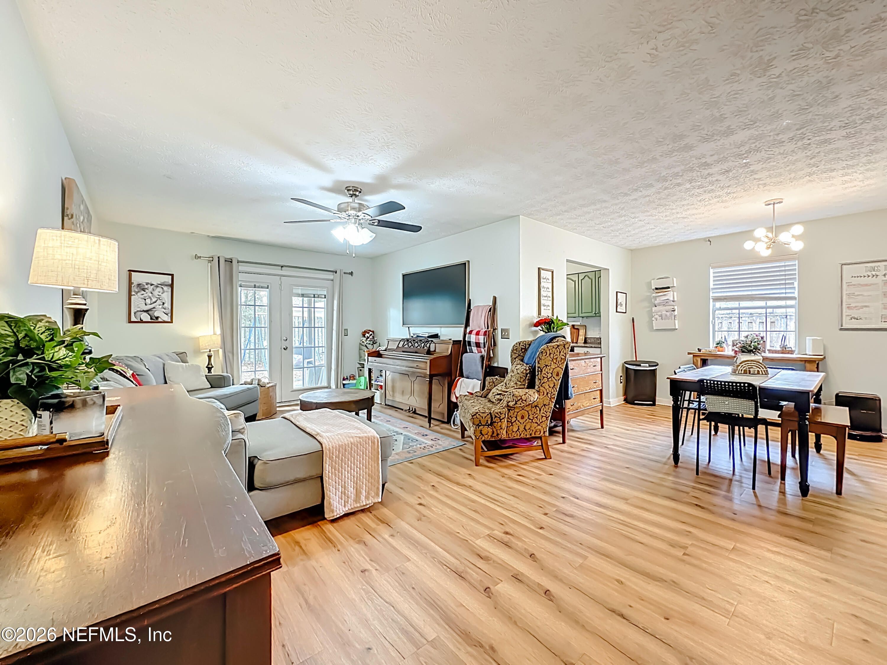 8302 Cassie Road Jacksonville, FL 32221 - Photo 12 of 48 a living room with furniture and a dining table with wooden floor
