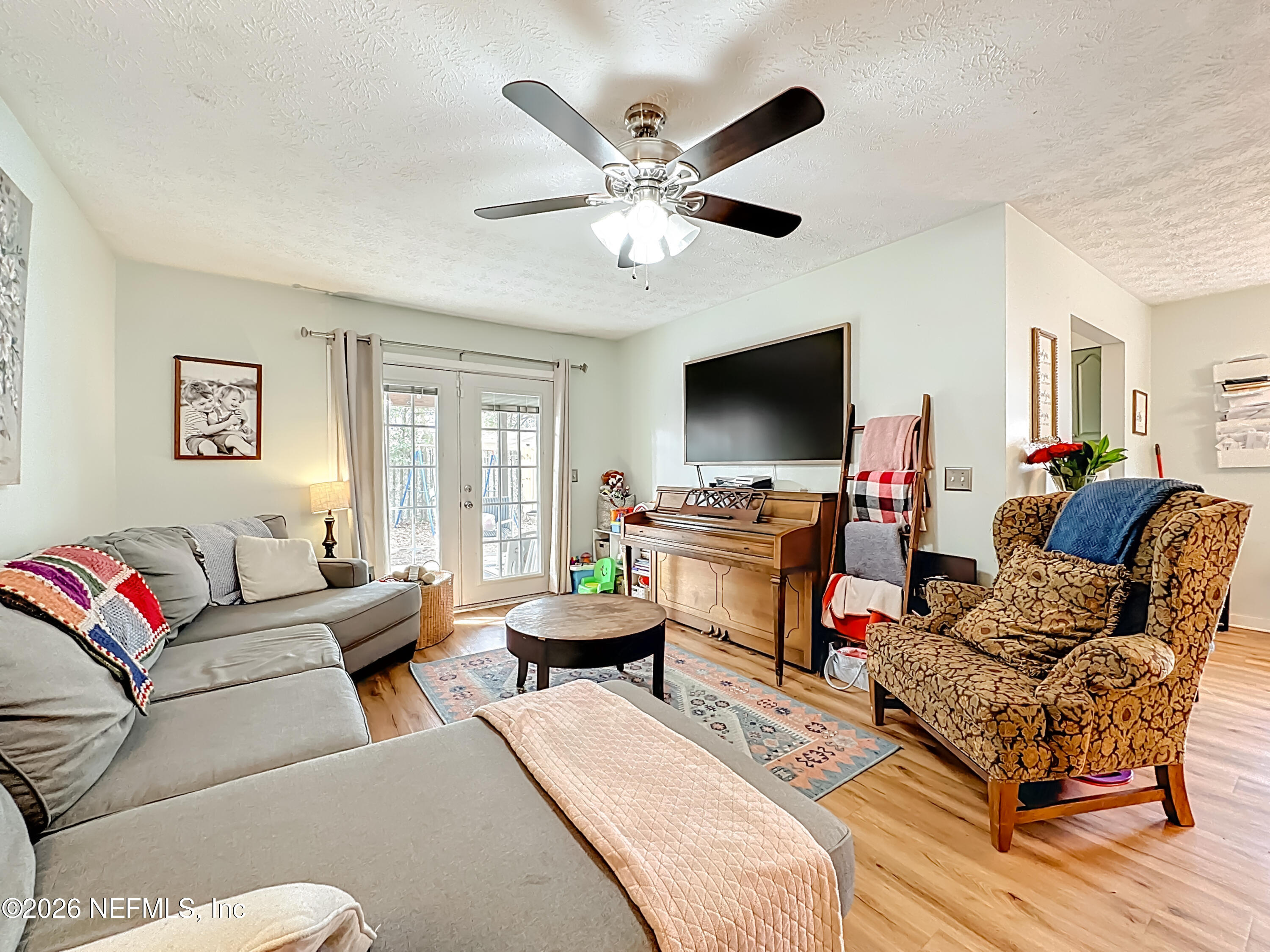 8302 Cassie Road Jacksonville, FL 32221 - Photo 13 of 48 a living room with furniture and a flat screen tv