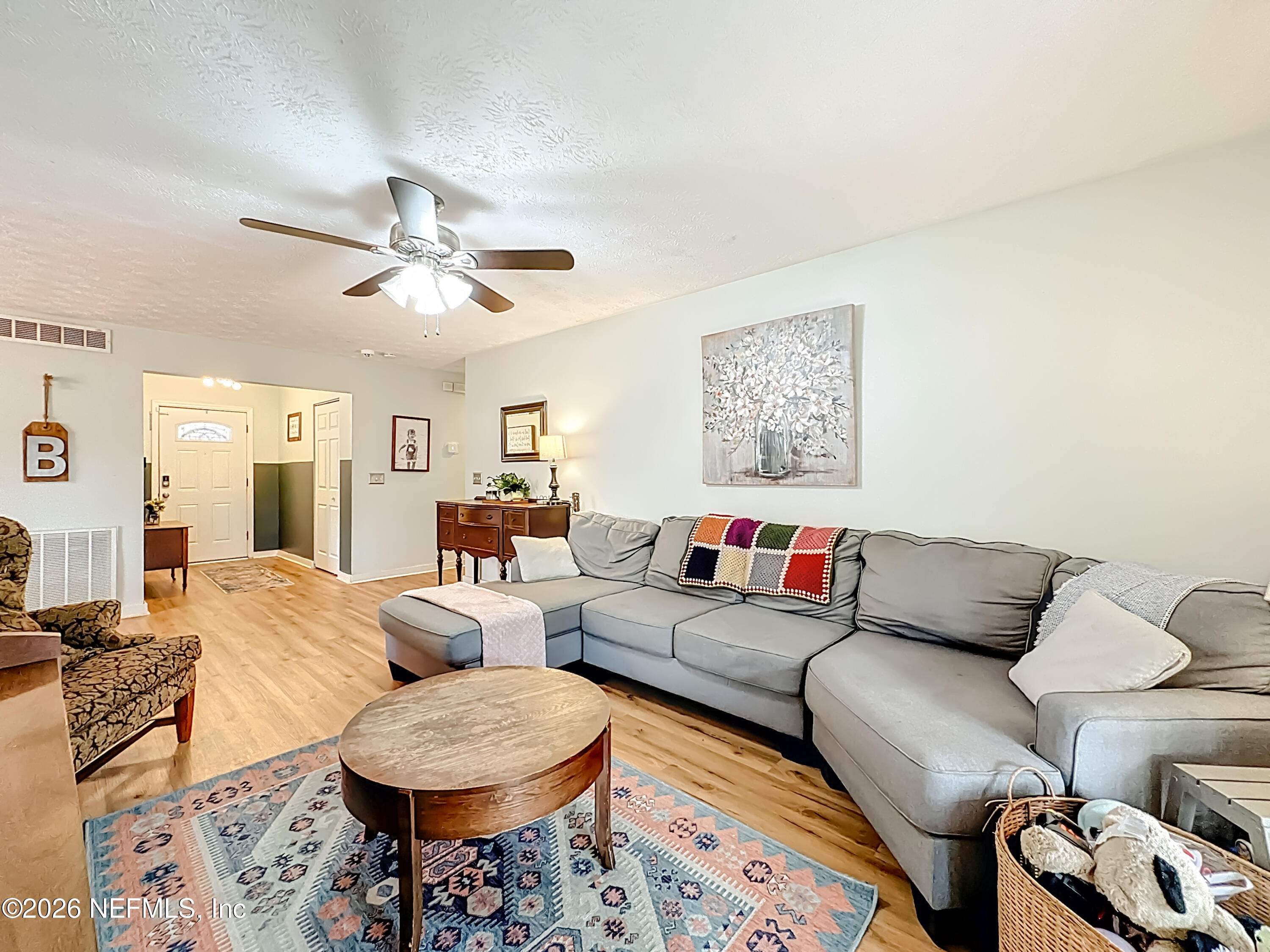 8302 Cassie Road Jacksonville, FL 32221 - Photo 15 of 48 a living room with furniture a rug and a window