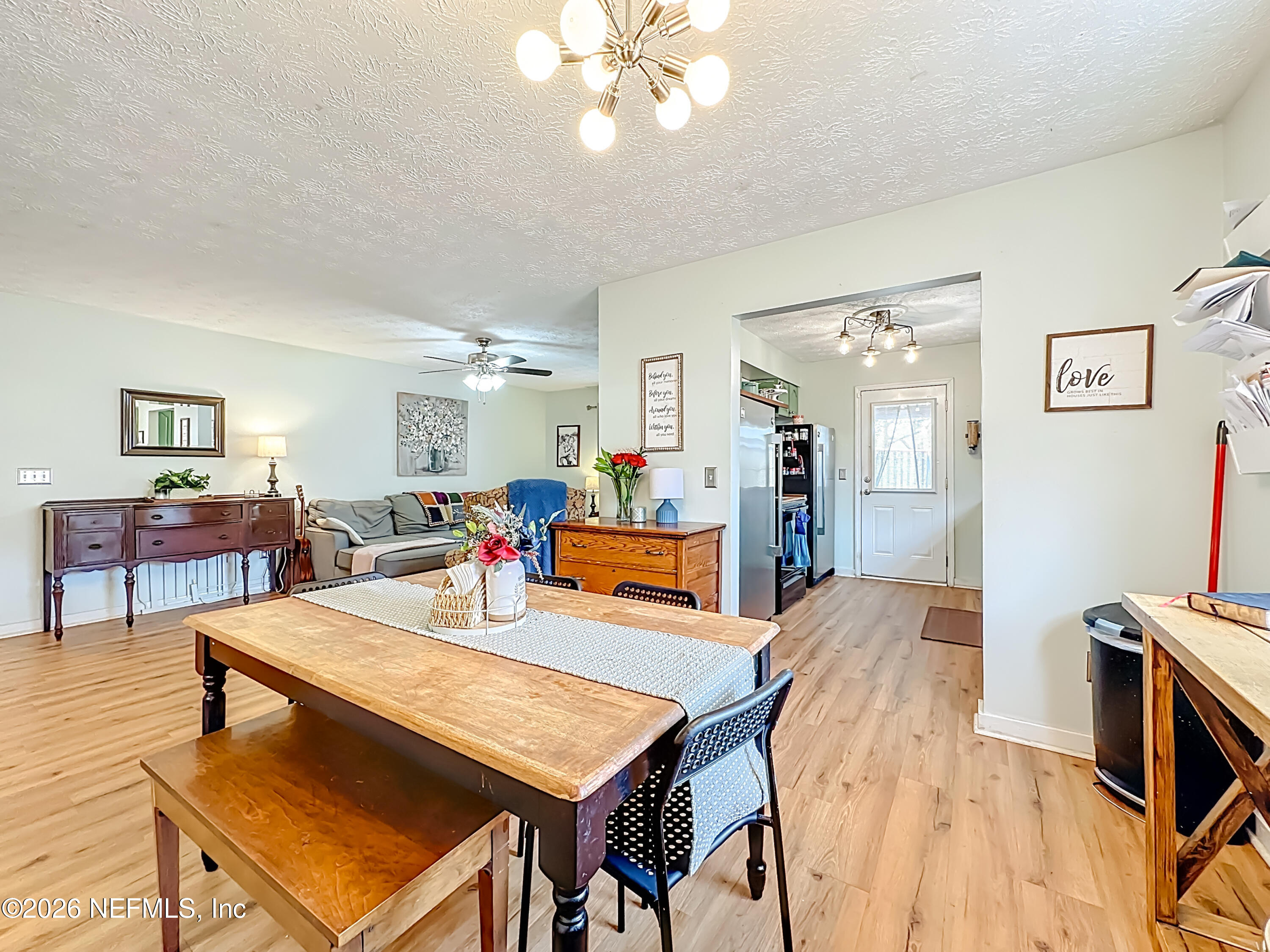 8302 Cassie Road Jacksonville, FL 32221 - Photo 17 of 48 a living room with stainless steel appliances kitchen island furniture and wooden floor