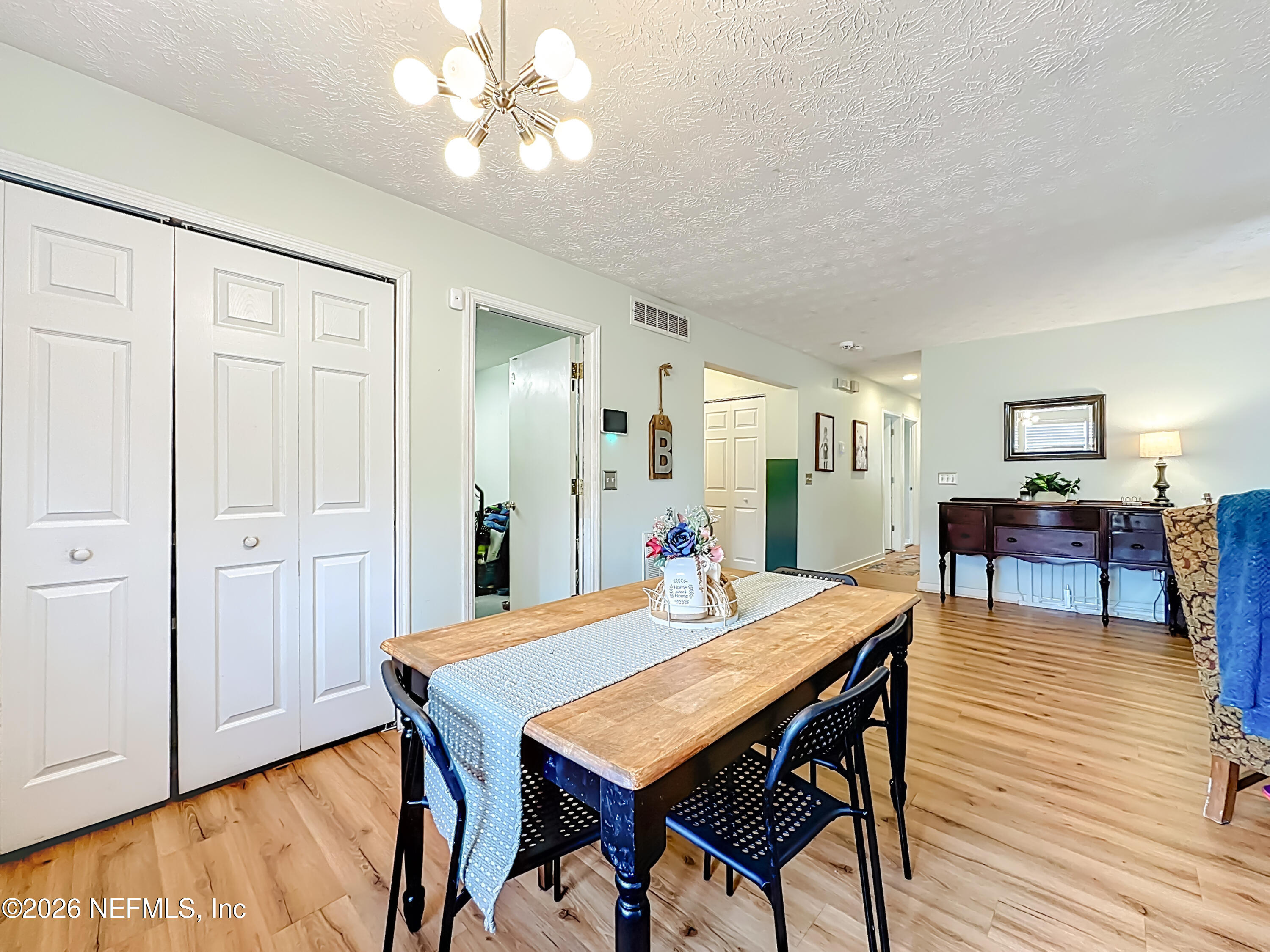8302 Cassie Road Jacksonville, FL 32221 - Photo 18 of 48 a view of a dining room with furniture and wooden floor