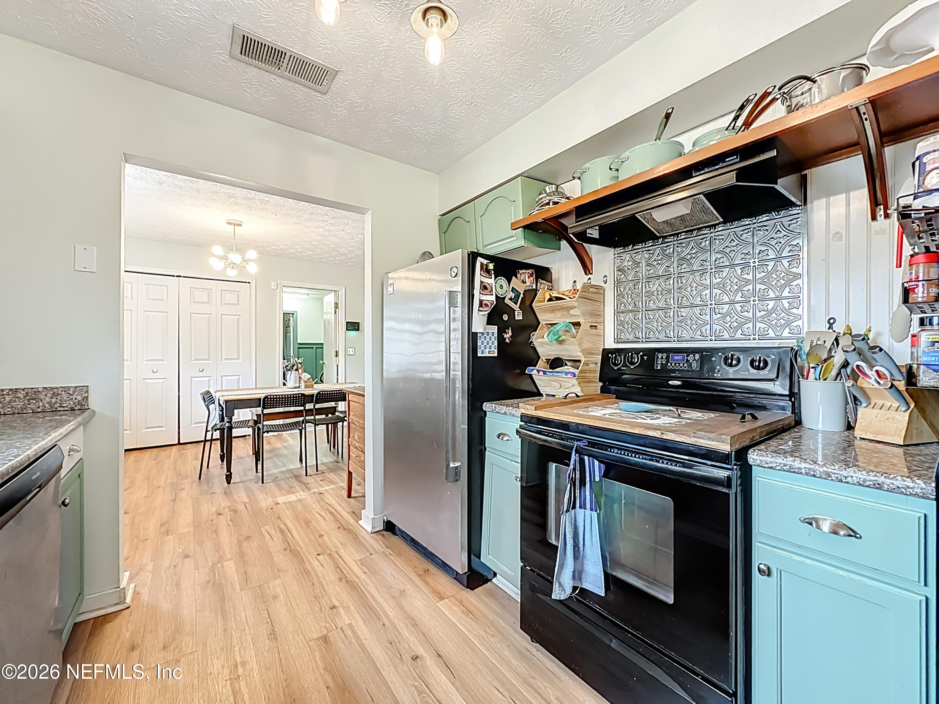 8302 Cassie Road Jacksonville, FL 32221 - Photo 21 of 48 a kitchen with a stove and a refrigerator