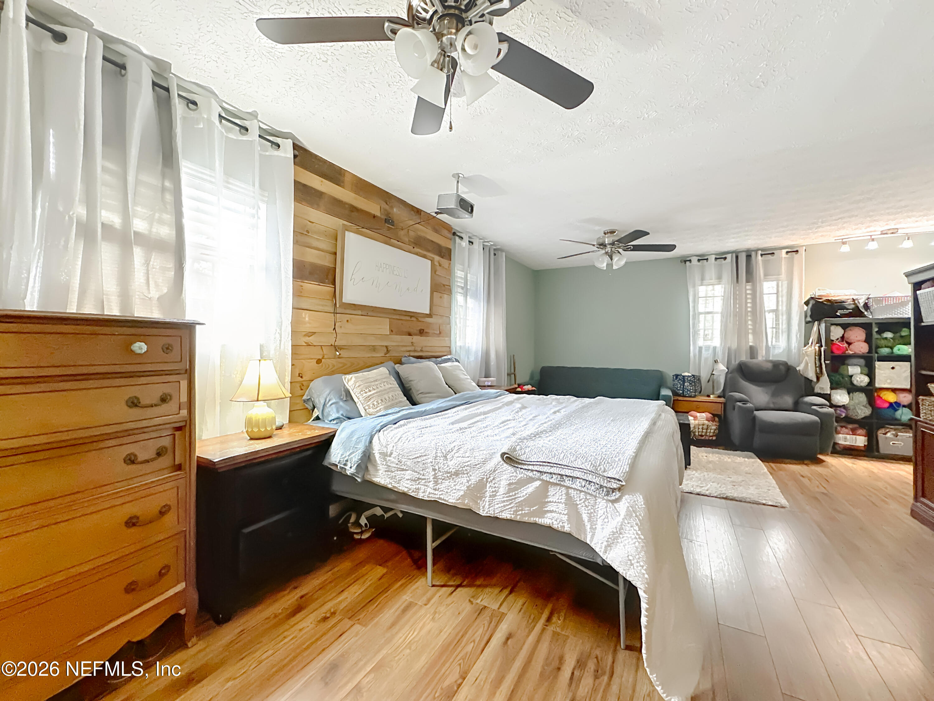 8302 Cassie Road Jacksonville, FL 32221 - Photo 23 of 48 a bedroom with a bed and wooden floor