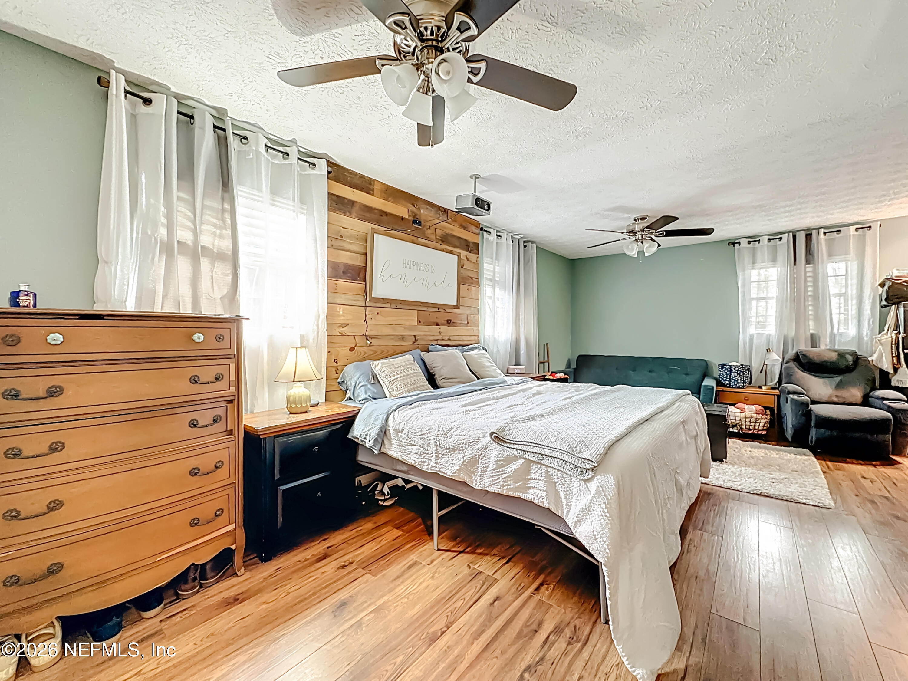 8302 Cassie Road Jacksonville, FL 32221 - Photo 24 of 48 a bedroom with a bed and wooden floor