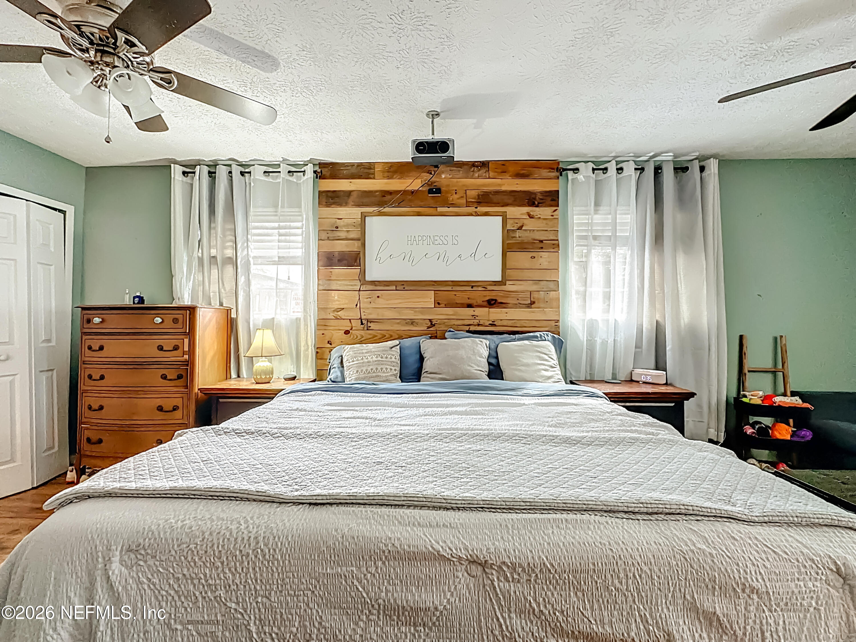 8302 Cassie Road Jacksonville, FL 32221 - Photo 25 of 48 a bedroom with a bed and a chandelier