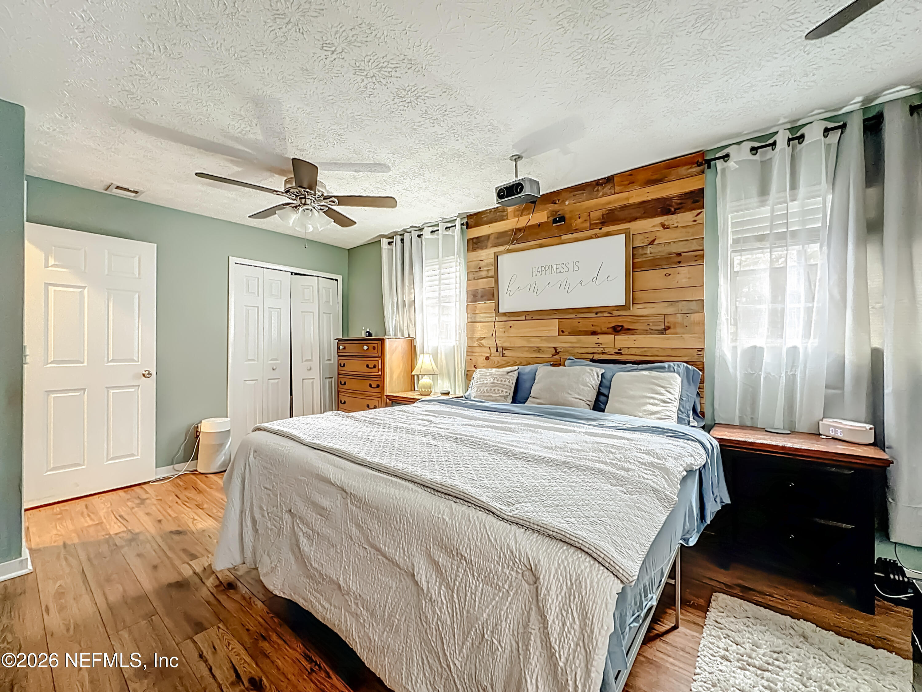 8302 Cassie Road Jacksonville, FL 32221 - Photo 26 of 48 a bedroom with a bed and a mirror