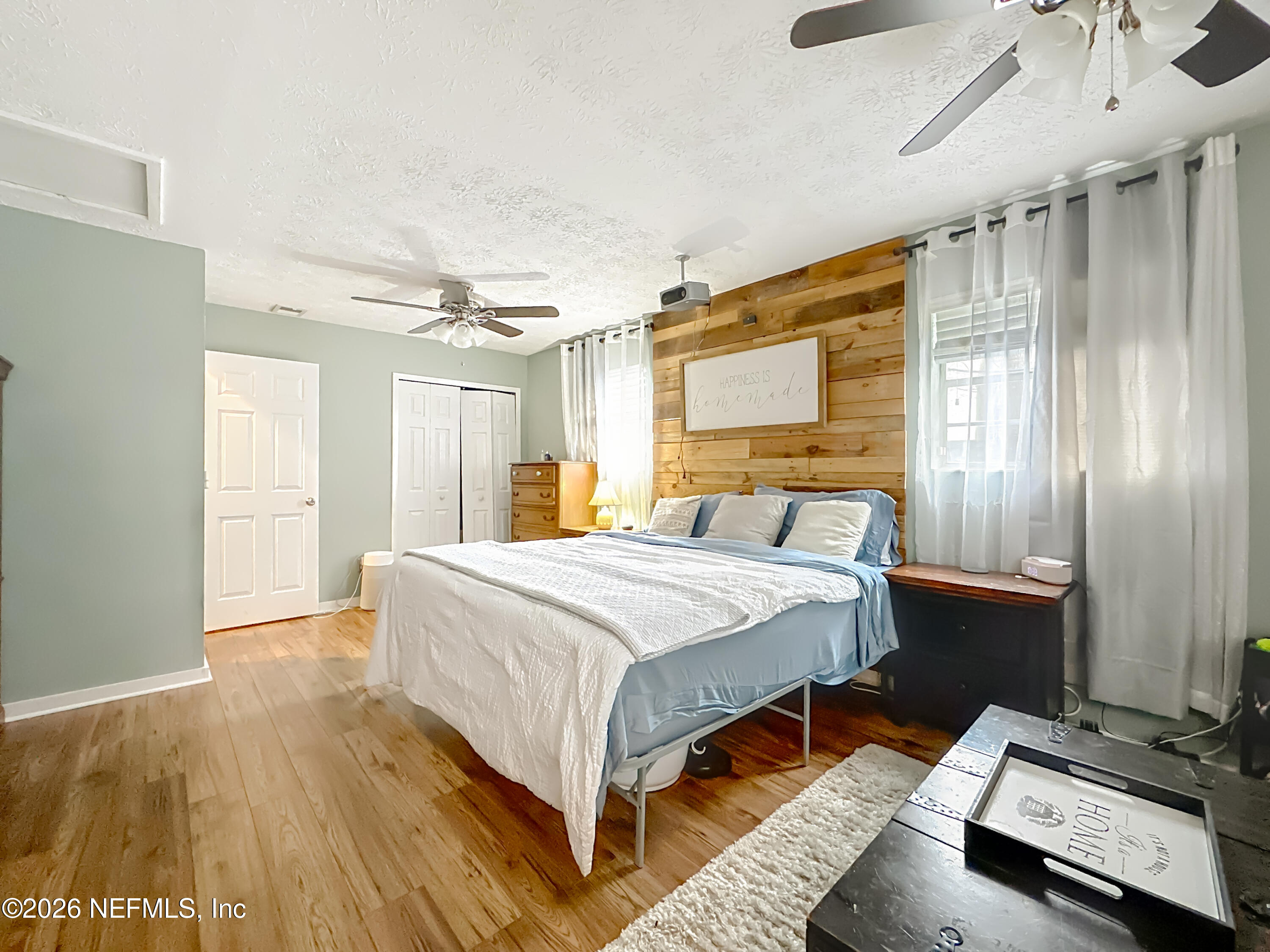 8302 Cassie Road Jacksonville, FL 32221 - Photo 27 of 48 a bedroom with a bed and wooden floor