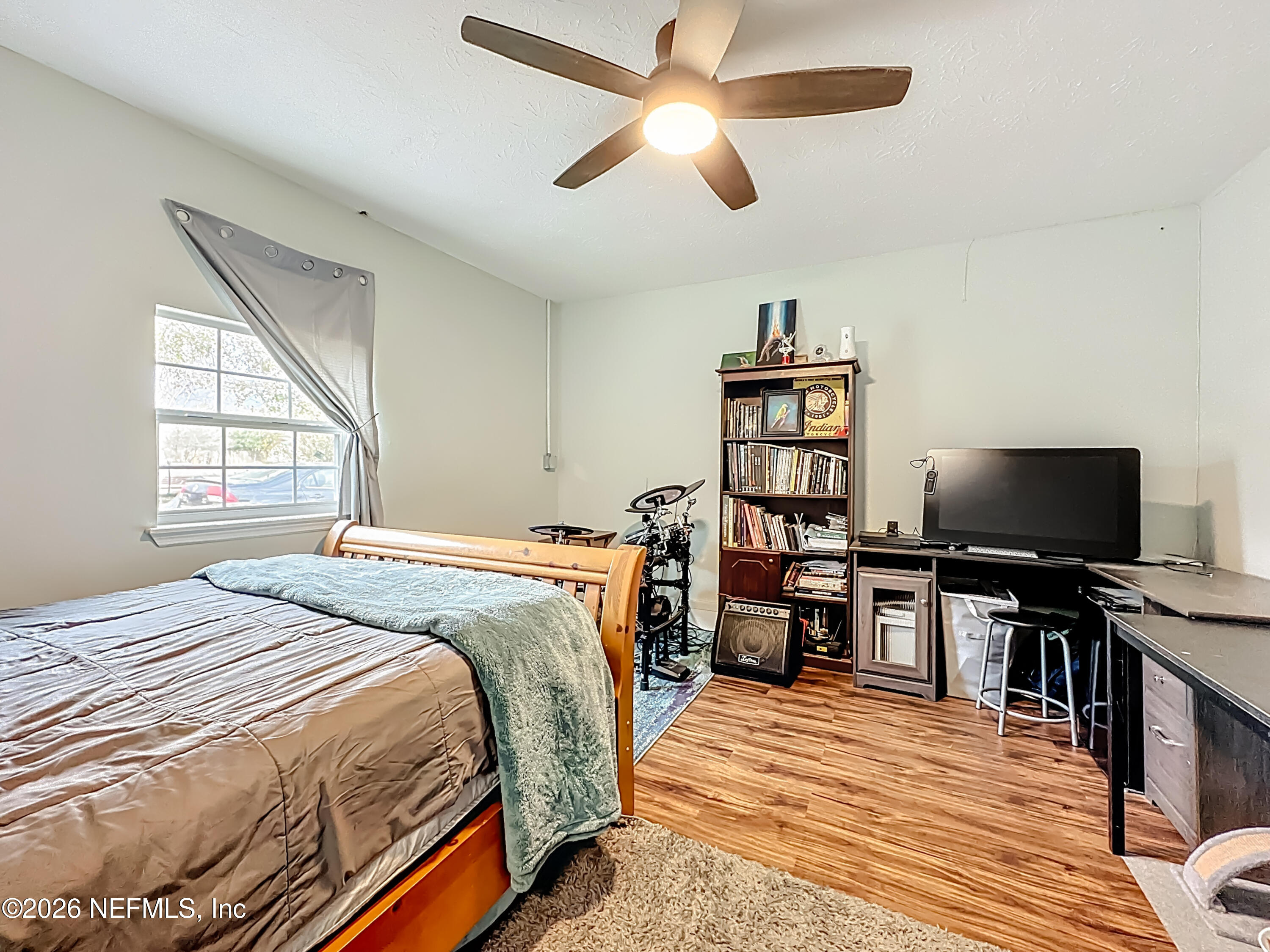 8302 Cassie Road Jacksonville, FL 32221 - Photo 37 of 48 a bedroom with a bed and a flat screen tv