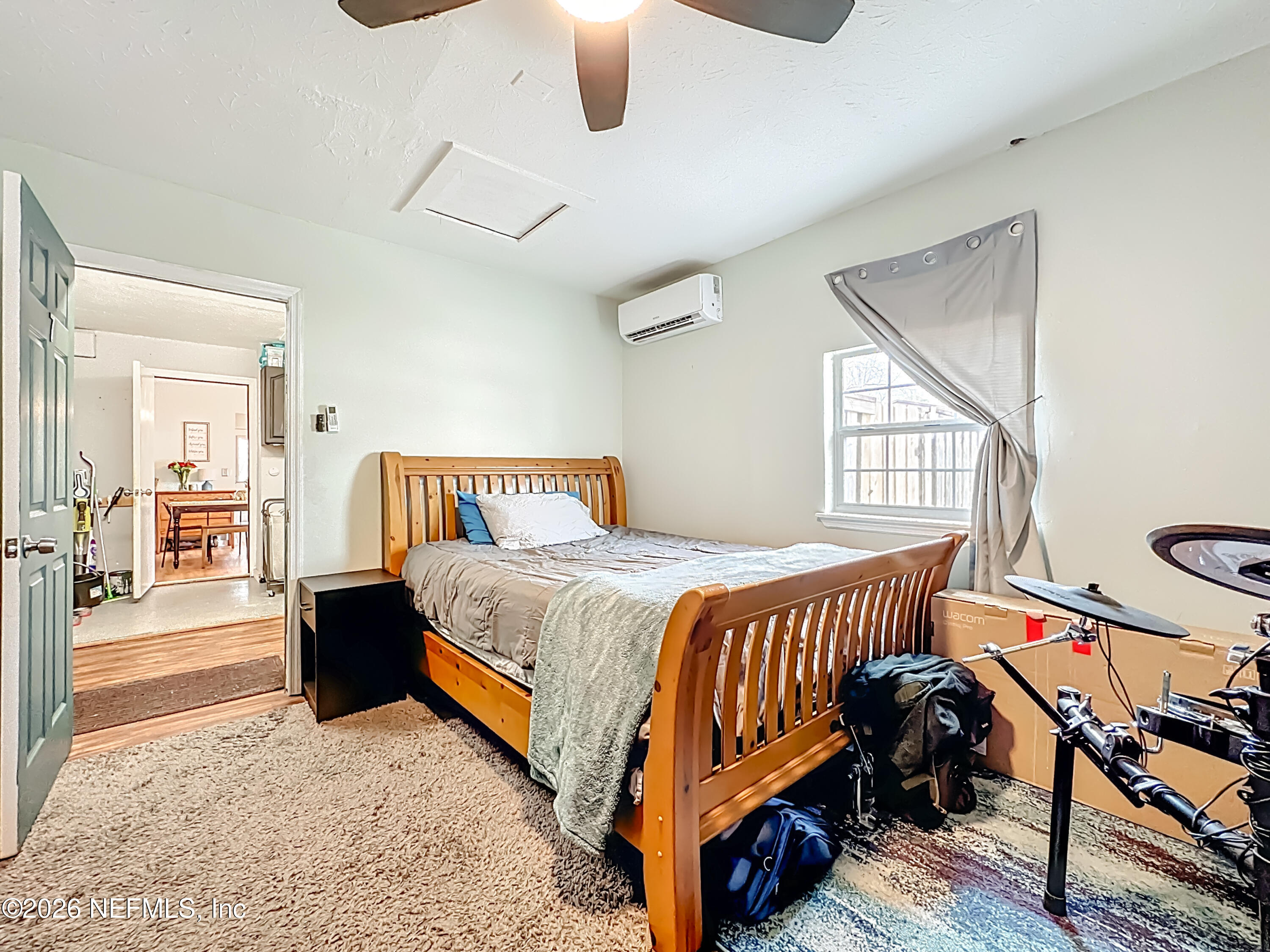 8302 Cassie Road Jacksonville, FL 32221 - Photo 38 of 48 a bedroom with a bed and wooden floor