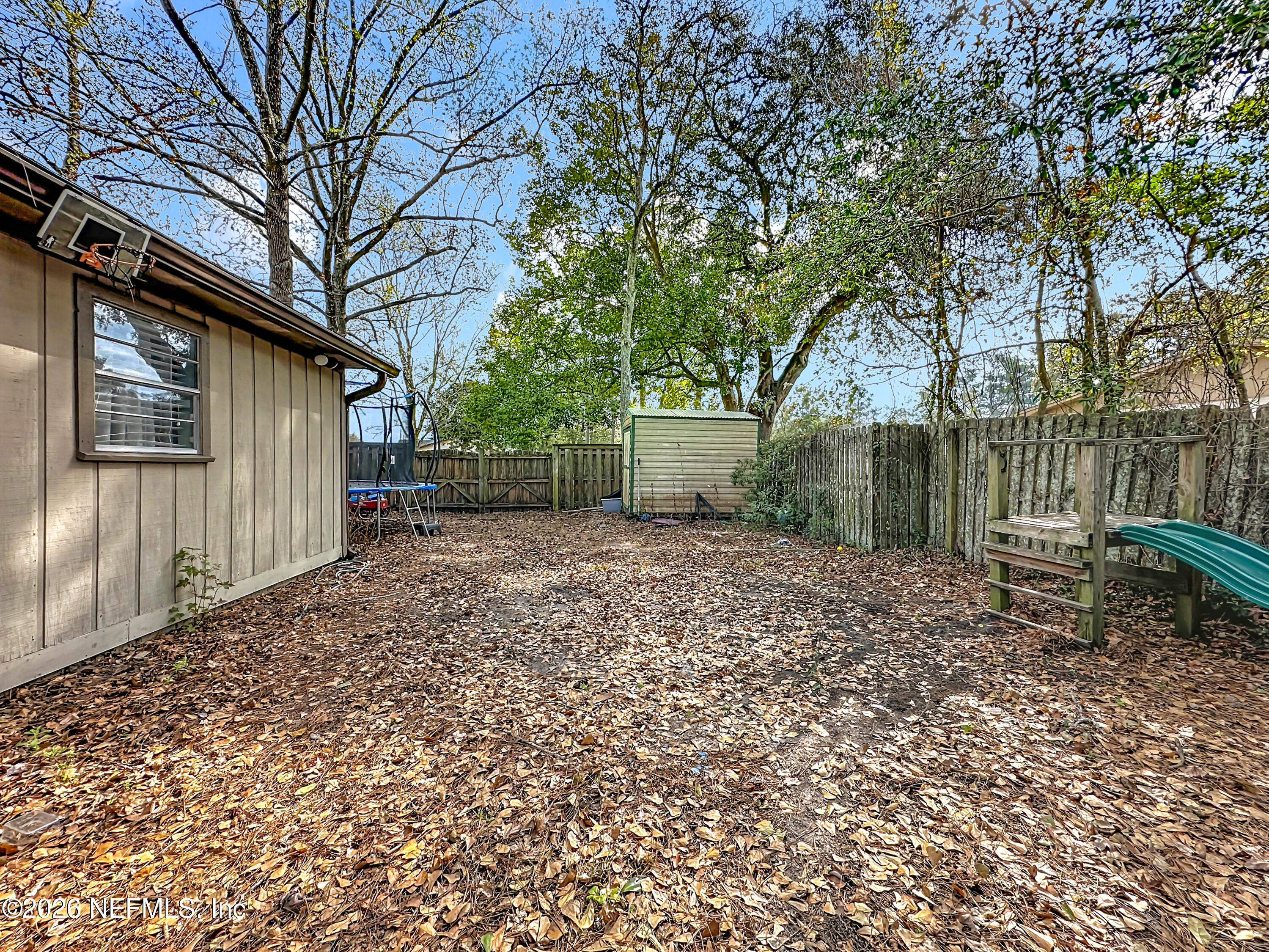 8302 Cassie Road Jacksonville, FL 32221 - Photo 42 of 48 a backyard of a house with lots of green space