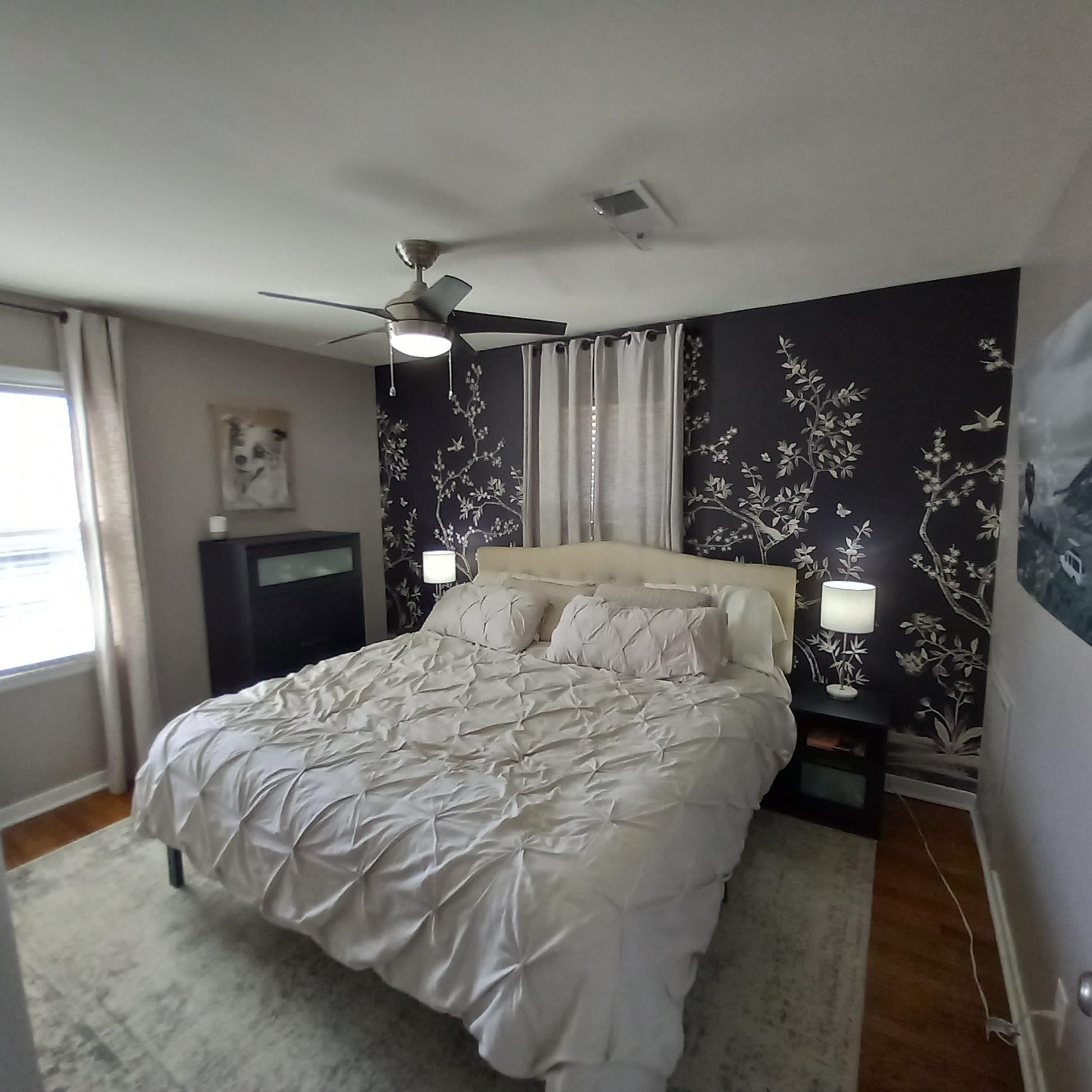 5068 Flamingo Road Memphis, TN 38117 - Photo 15 of 20 a large bed sitting in a bedroom and chandelier next to a window
