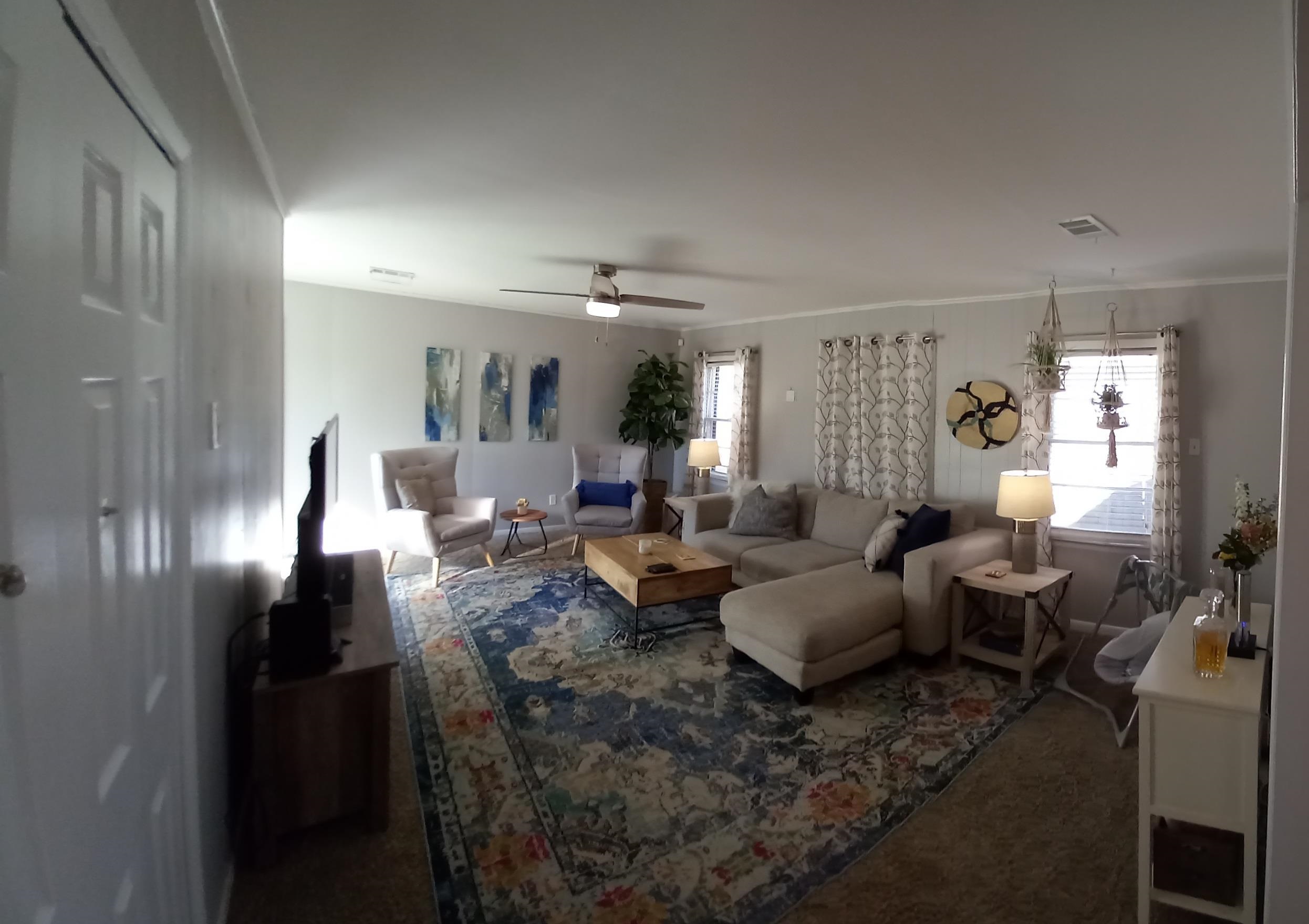 5068 Flamingo Road Memphis, TN 38117 - Photo 4 of 20 a living room with lots of white furniture and a chandelier