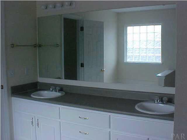 132 Gunwale Road Pensacola, FL 32507 - Photo 11 of 13 double vanity reflects not just the glass block window but the closet