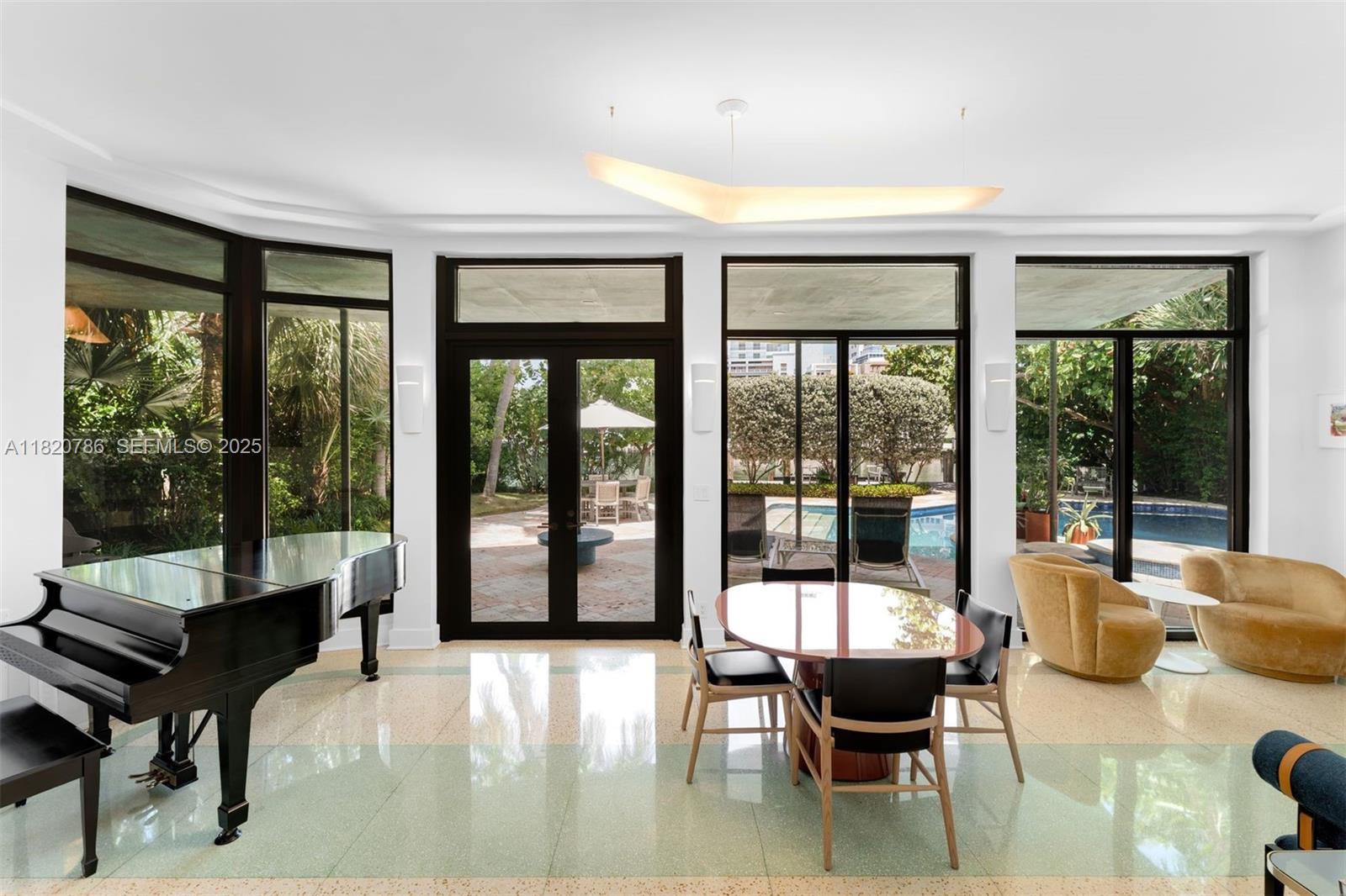 6165 Pine Tree Drive Miami Beach, FL 33140 - Photo 16 of 33 a living room with furniture and a large window