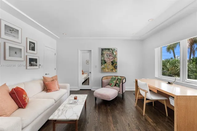 a bedroom with a bed a couch and a window