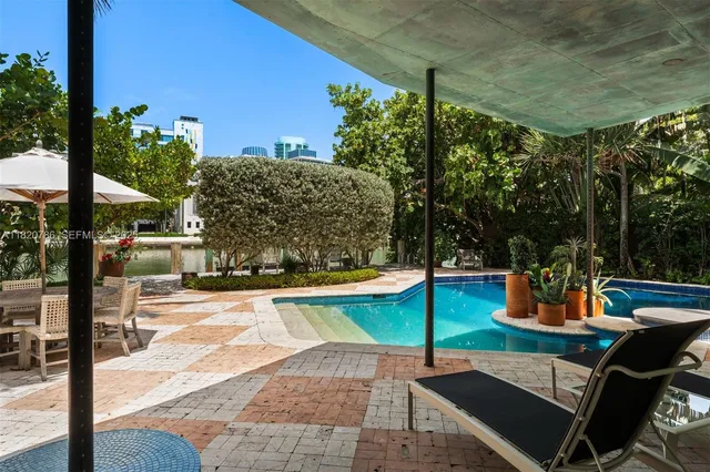 a living room with furniture cabinets and book shelf
