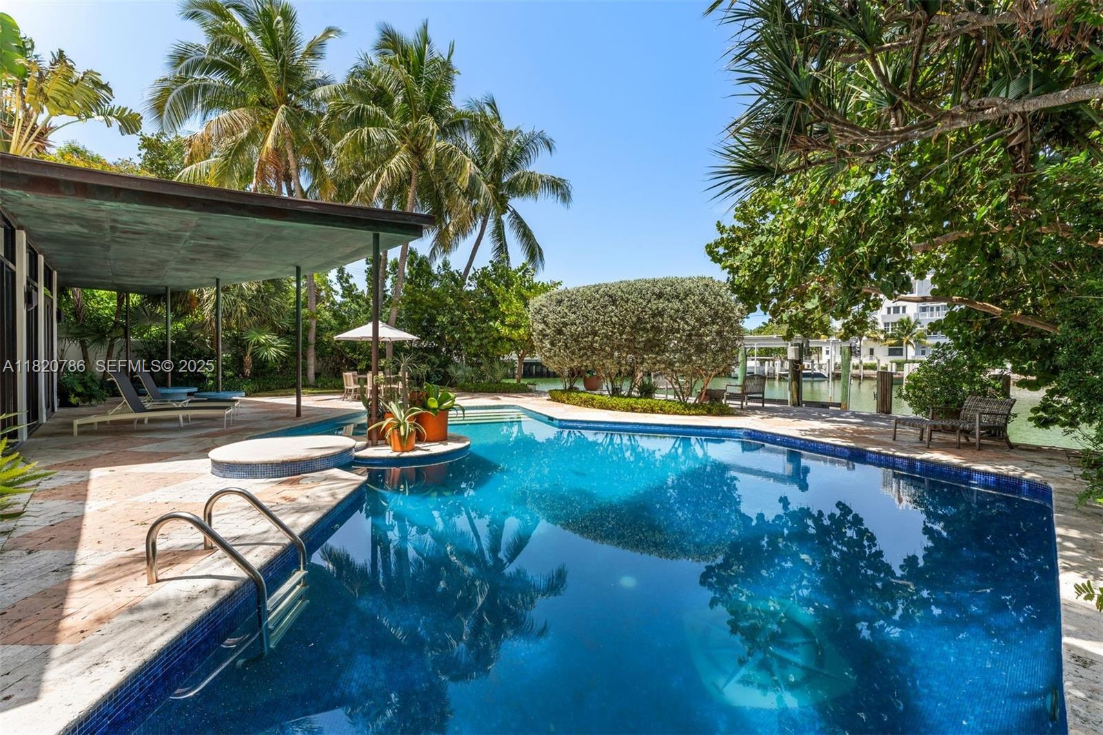6165 Pine Tree Drive Miami Beach, FL 33140 - Photo 3 of 33 a view of swimming pool with a patio