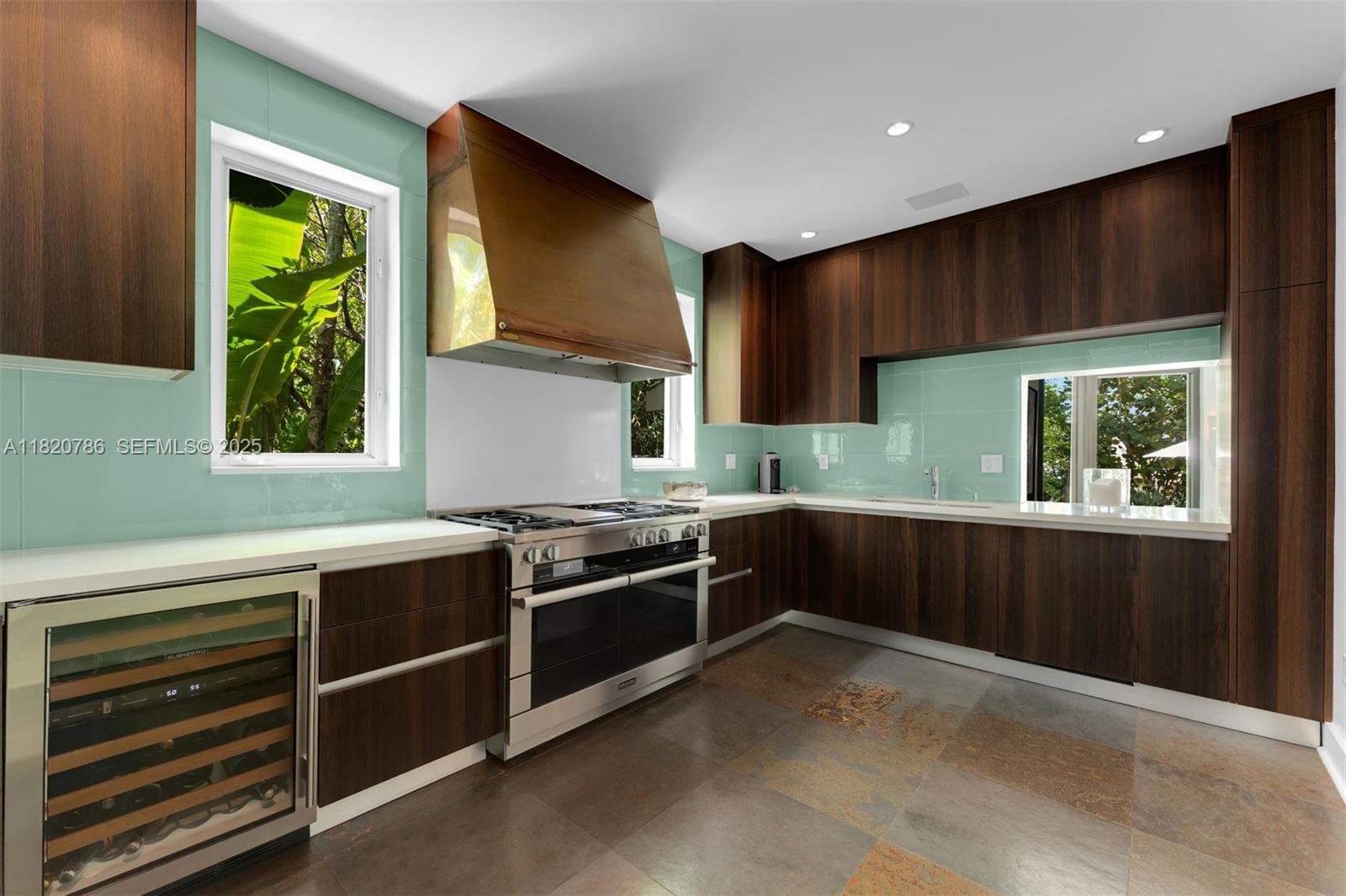 6165 Pine Tree Drive Miami Beach, FL 33140 - Photo 33 of 33 a kitchen with stainless steel appliances granite countertop a stove a sink and a microwave