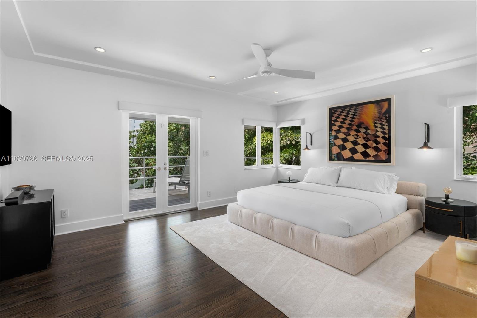 6165 Pine Tree Drive Miami Beach, FL 33140 - Photo 5 of 33 a spacious bedroom with a large bed and a couch