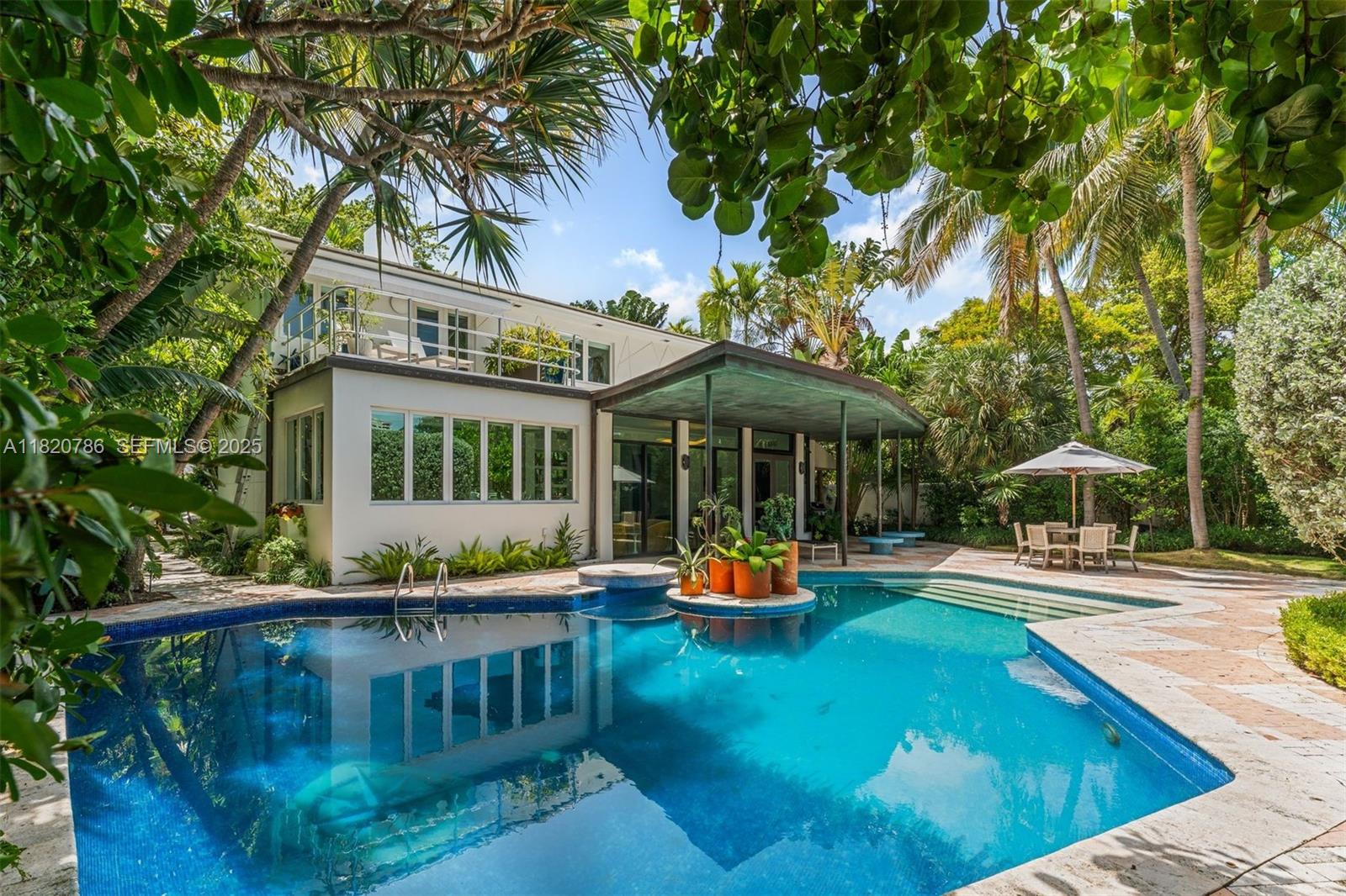 6165 Pine Tree Drive Miami Beach, FL 33140 - Photo 9 of 33 a view of a swimming pool with a patio