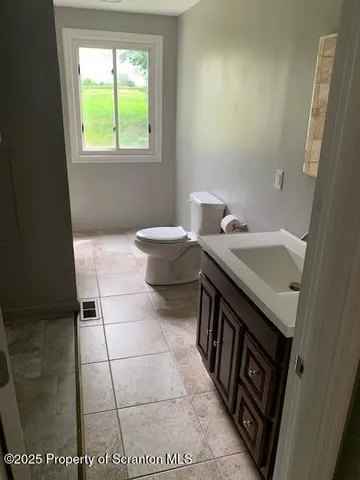 a view of a hallway with wooden floor and stairs