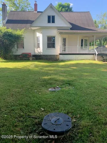 a view of a wooden house with a yard