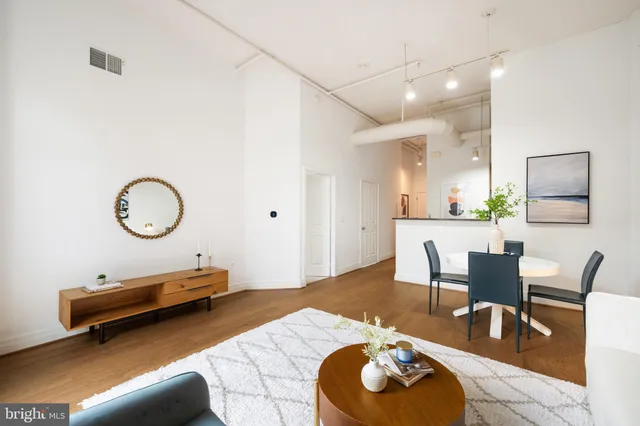 a living room with furniture a rug and a chair