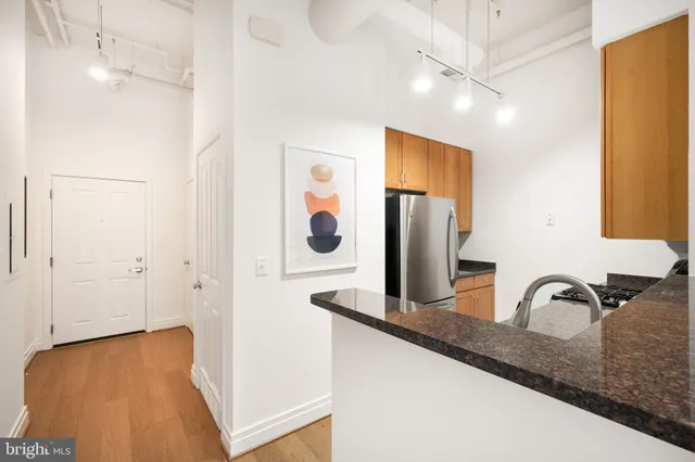 a kitchen with kitchen island a sink appliances and cabinets